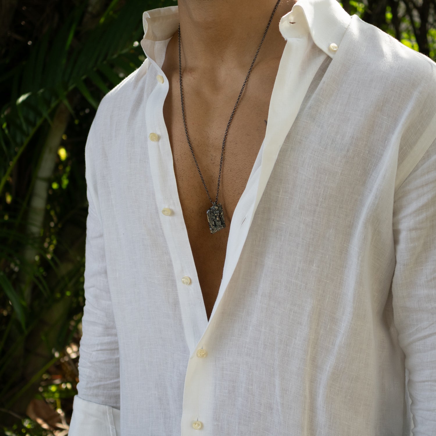 Sterling silver necklace with intricately detailed Santa Muerte pendant, dark rhodium-plated finish, black accents, sturdy silver chain, gothic style.