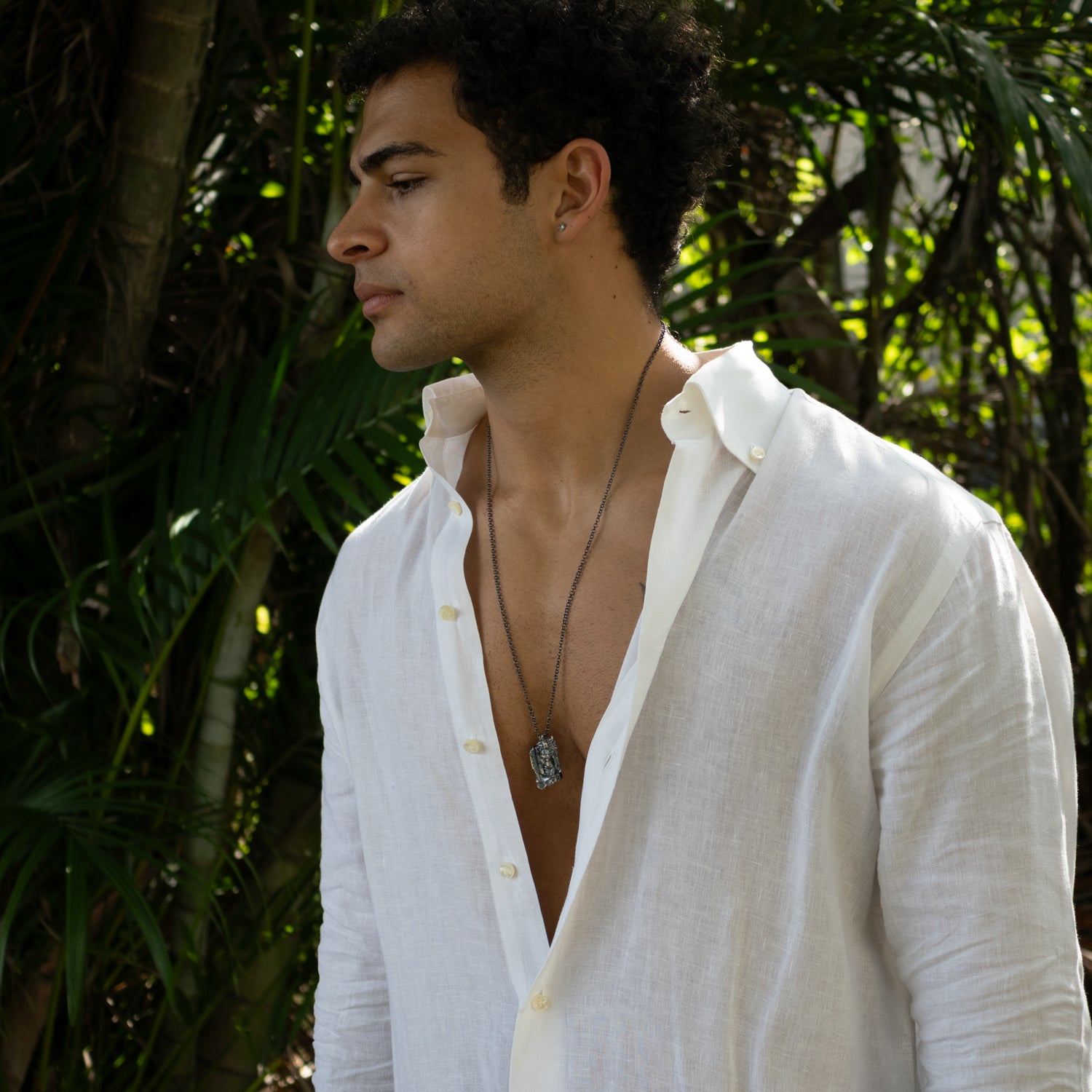 Sterling silver necklace with detailed Santa Muerte pendant, dark rhodium-plated finish, black accents, strong silver chain, bold gothic style.