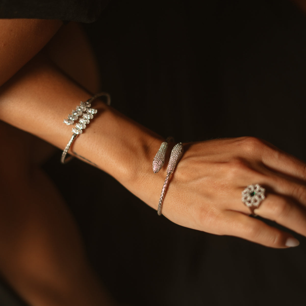 Twin serpent pave silver cuff worn on the wrist with the Elegant Marquise Diamond Bypass cuff and a silver cocktail ring