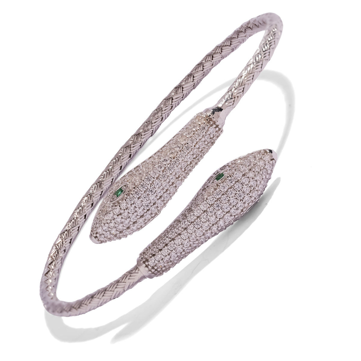 Close view of the two pave white zircon serpent heads with emerald green eyes on the sterling silver cuff