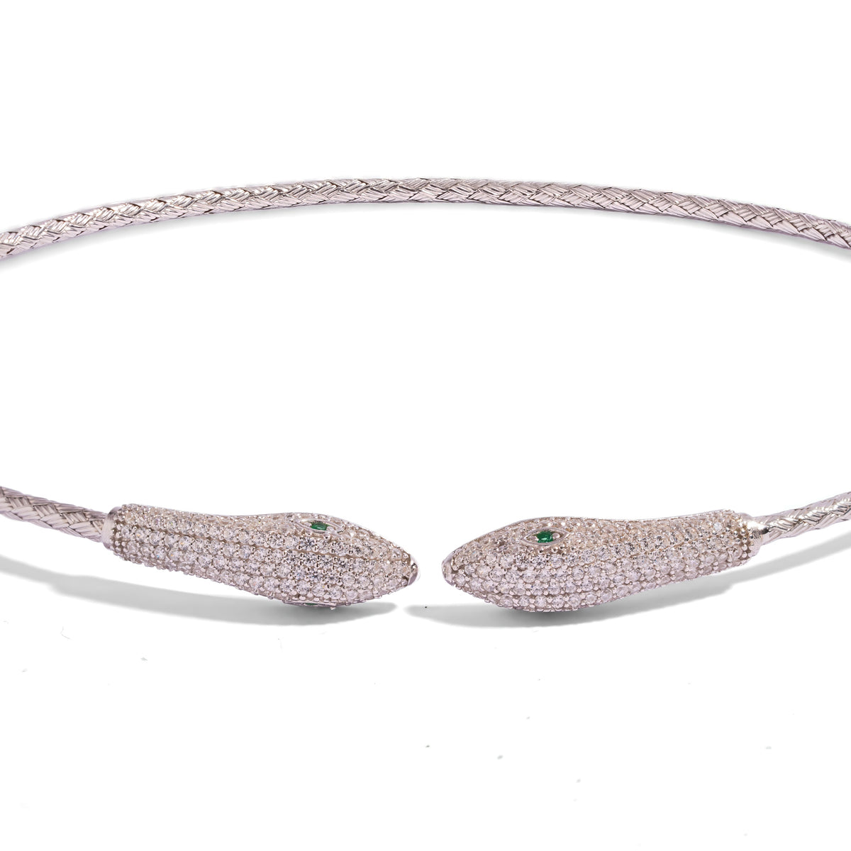 Detail of the two pave serpent heads with emerald green eyes on the woven silver band