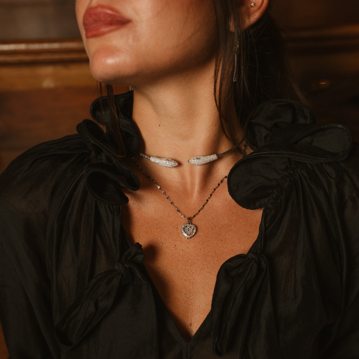 Close up of the silver serpent choker worn at the throat with a black blouse