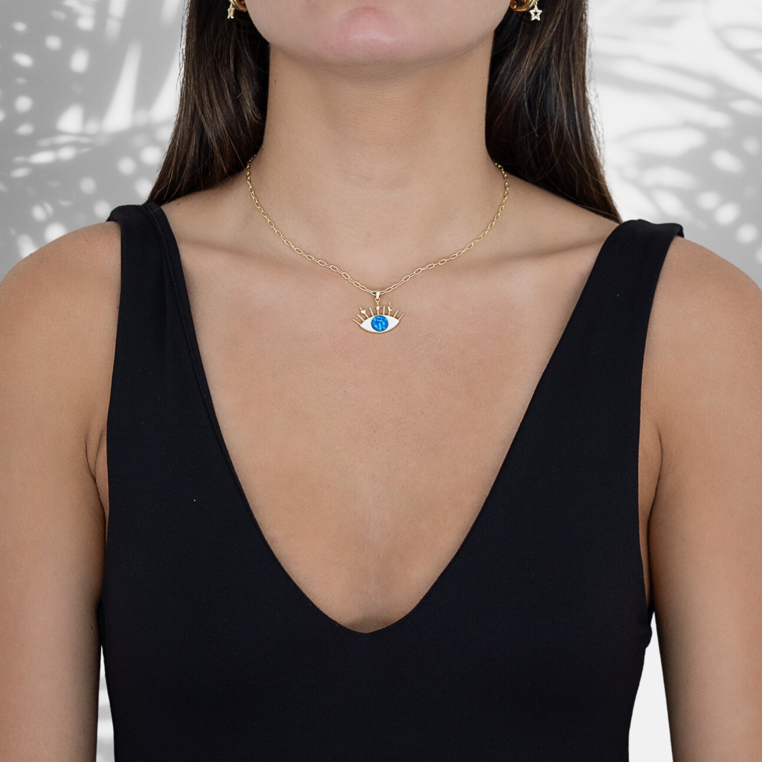 A model wearing the Silver Blue Opal Evil Eye Necklace, radiating style and spiritual energy.
