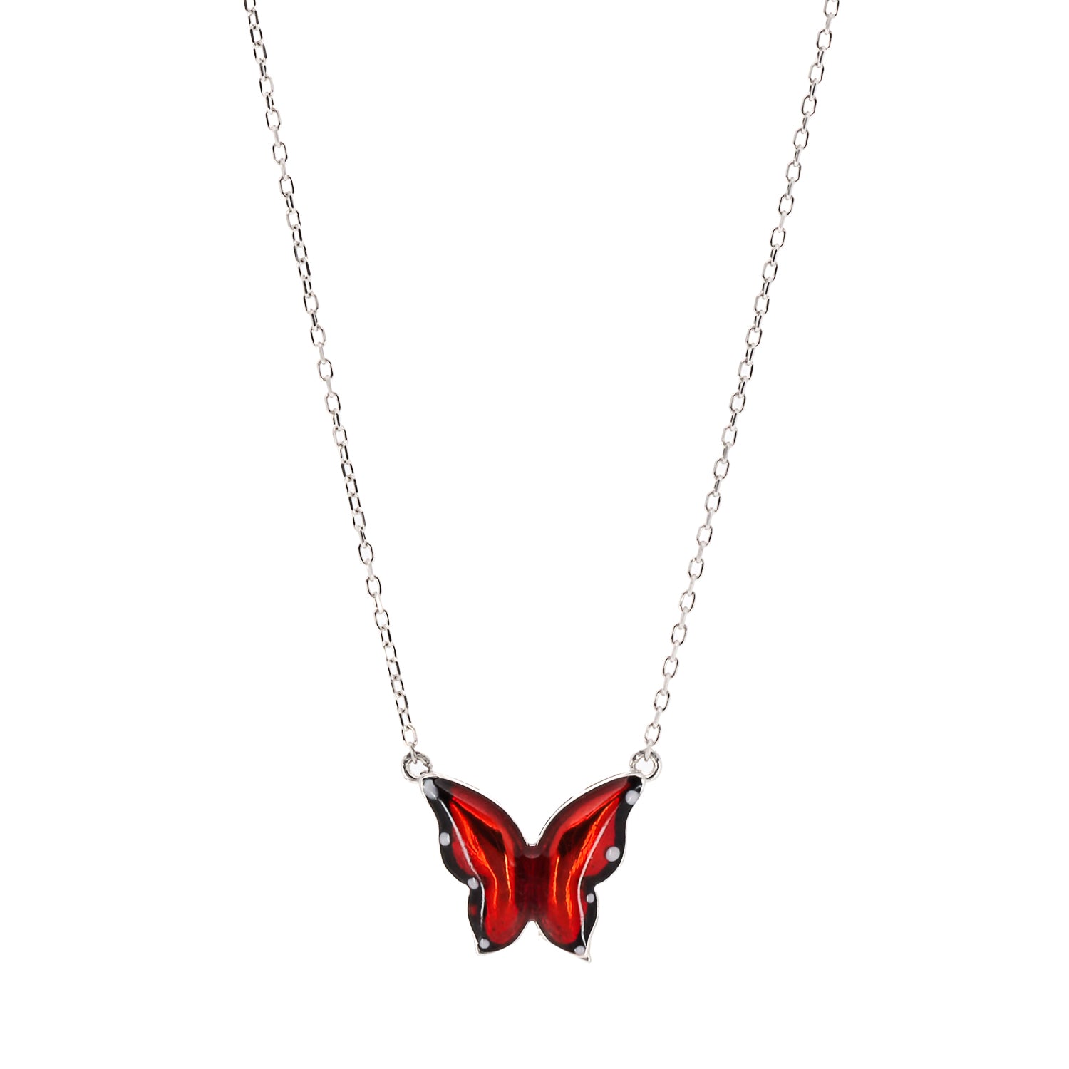 Close-up shot of the intricate red enamel design on the butterfly pendant, symbolizing transformation and spiritual growth.