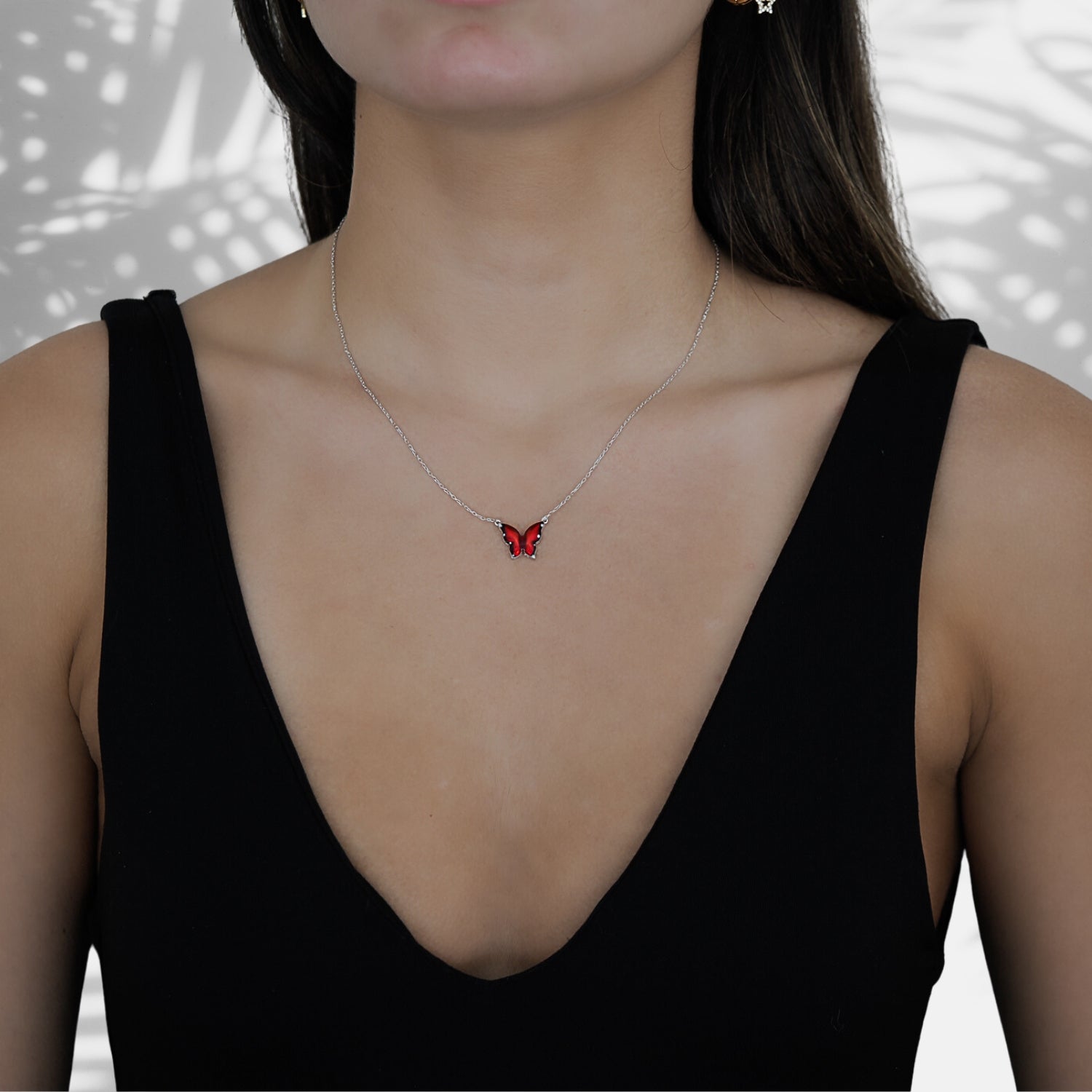 Model wearing the Silver Joy Red Enamel Butterfly Necklace, showcasing its unique design and the transformative energy it symbolizes.