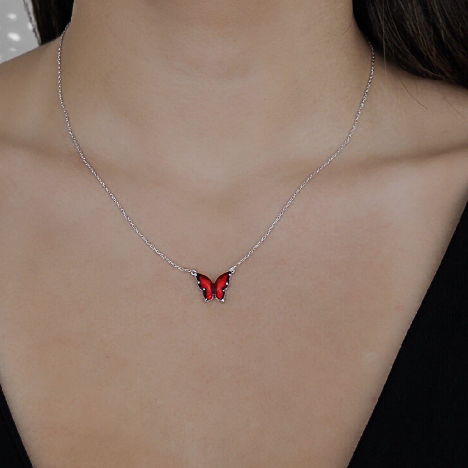 Model wearing the Silver Joy Red Enamel Butterfly Necklace, radiating confidence and embracing the symbolism of transformation.