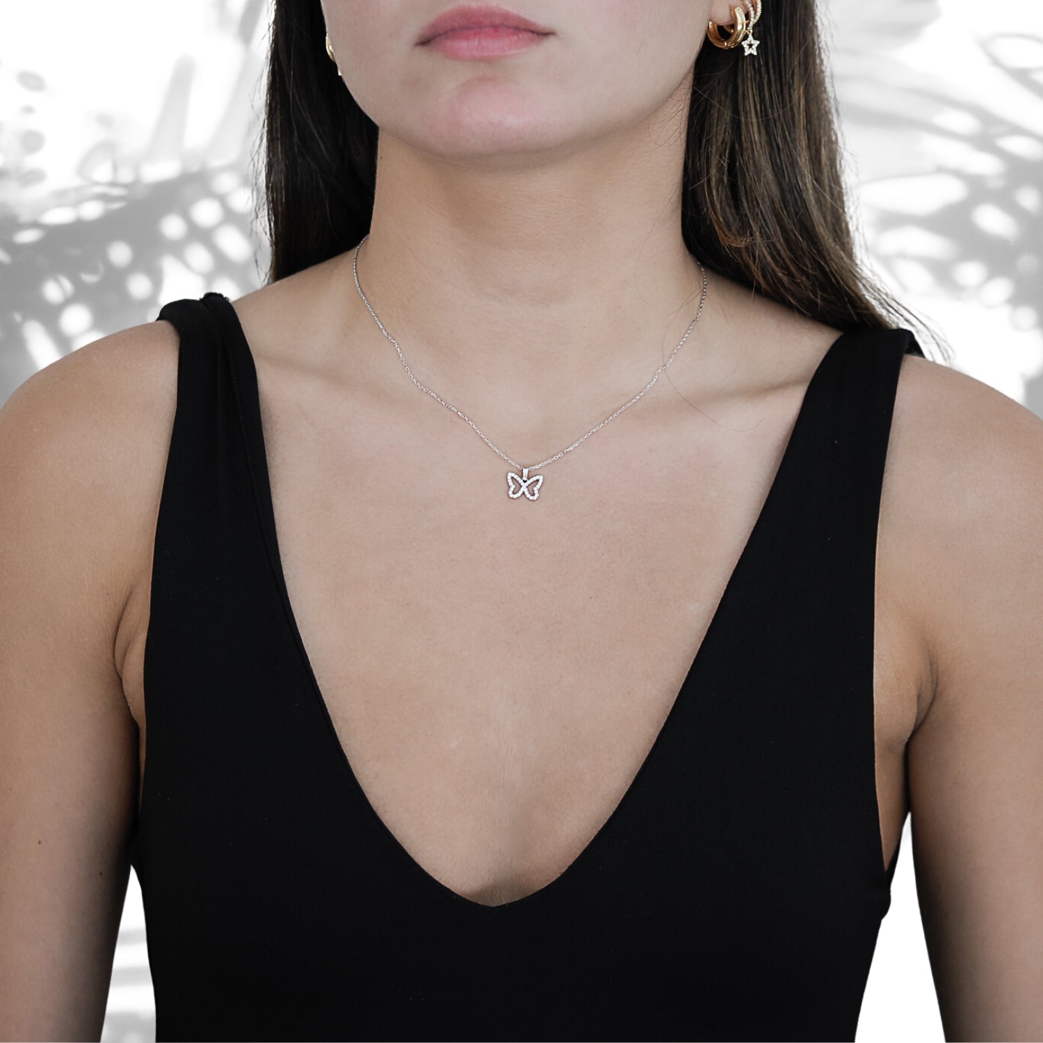 A model wearing the Silver Sparkly Butterfly Necklace, radiating elegance and grace.