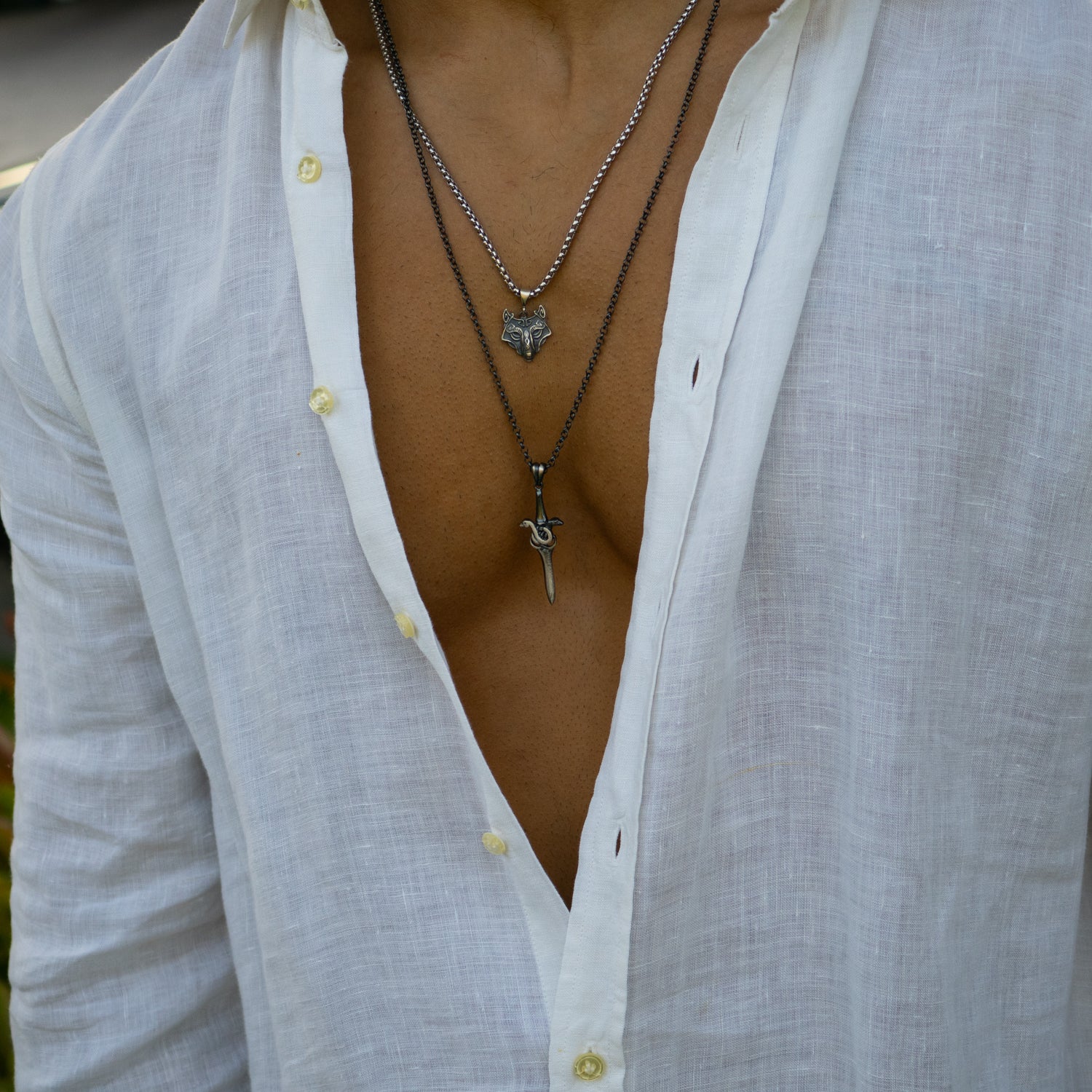 Sterling silver necklace with intricately detailed wolf head pendant, oxidized finish, strong silver chain, bold protective masculine style.