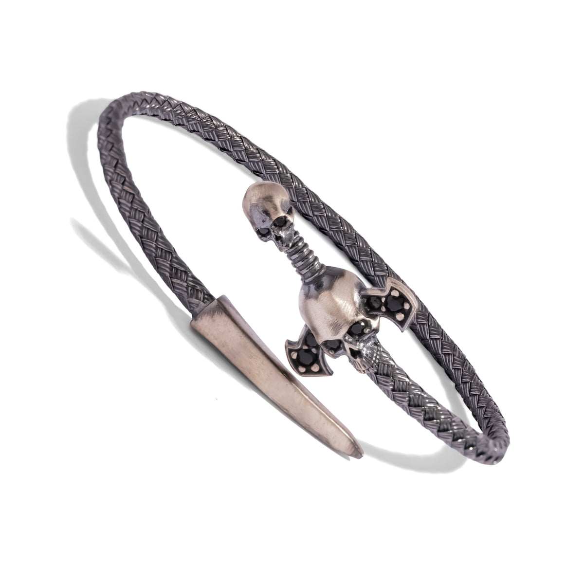 Angled view of the oxidized woven silver band wrapping into the skull hilt and polished dagger blade