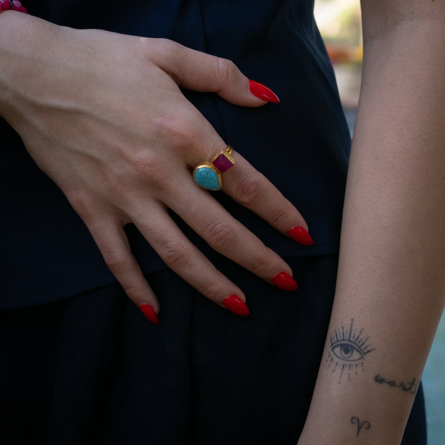 Handmade statement ring featuring natural turquoise and fiery ruby in gold-plated setting

