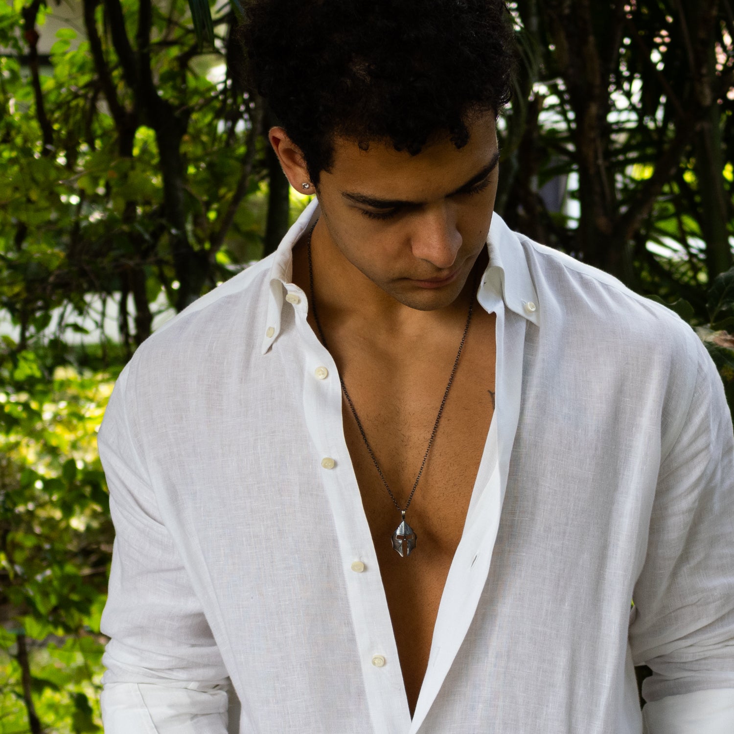 Sterling silver necklace with Spartan helmet pendant, rhodium and oxidized black finish, bold masculine style symbolizing courage and honor.