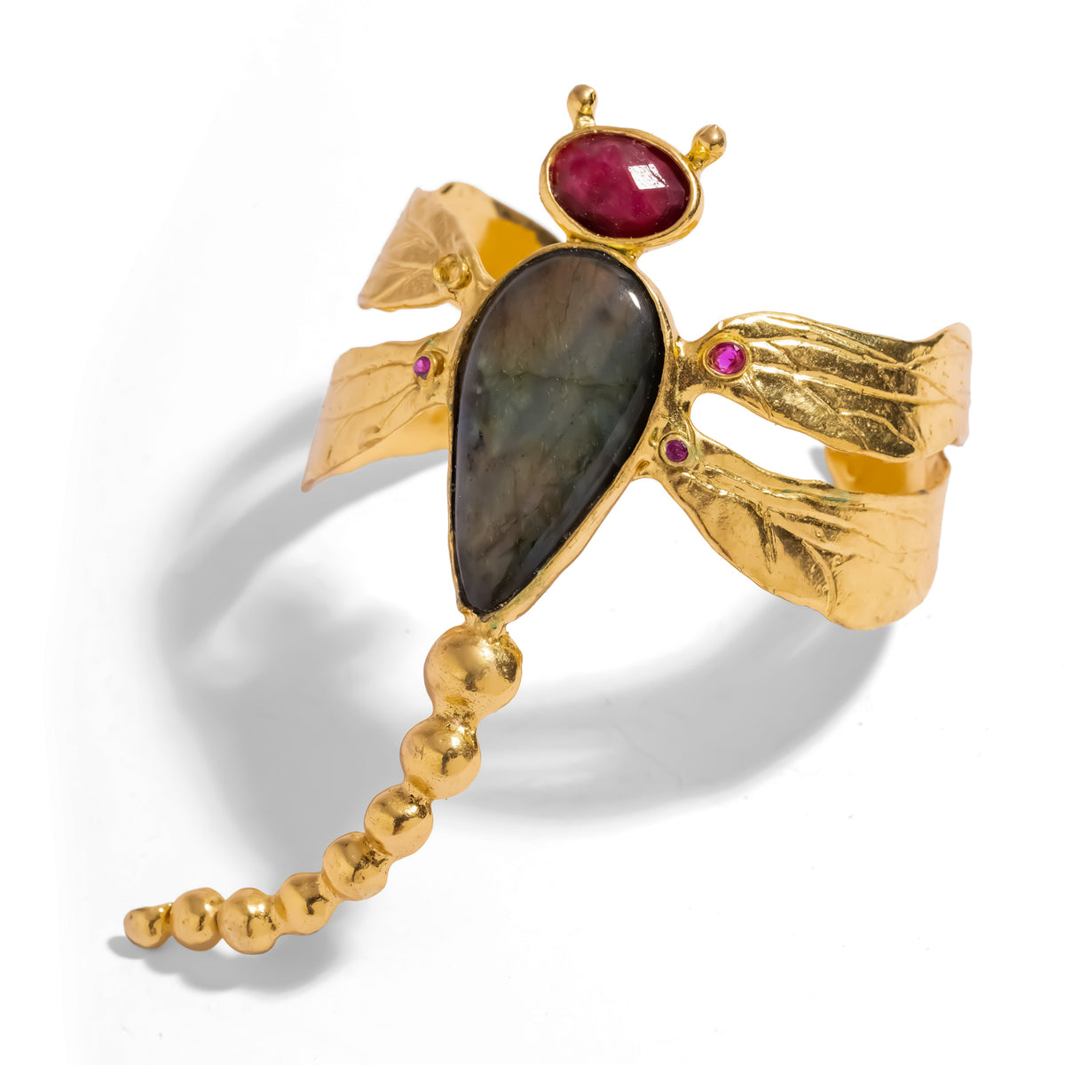 Close view of the dragonfly cuff showing the labradorite body, faceted ruby head and hand textured gold wings