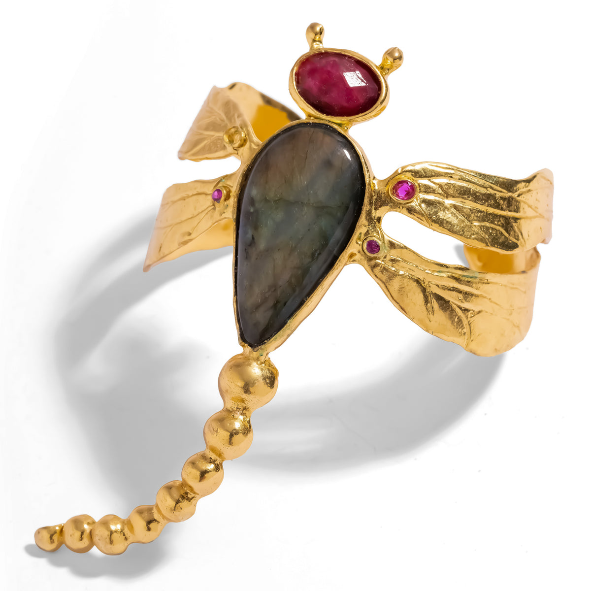 Spiritual Dragonfly Labradorite & Ruby Gold Cuff Bracelet at an angle, graduated gold bead tail curving from the labradorite body