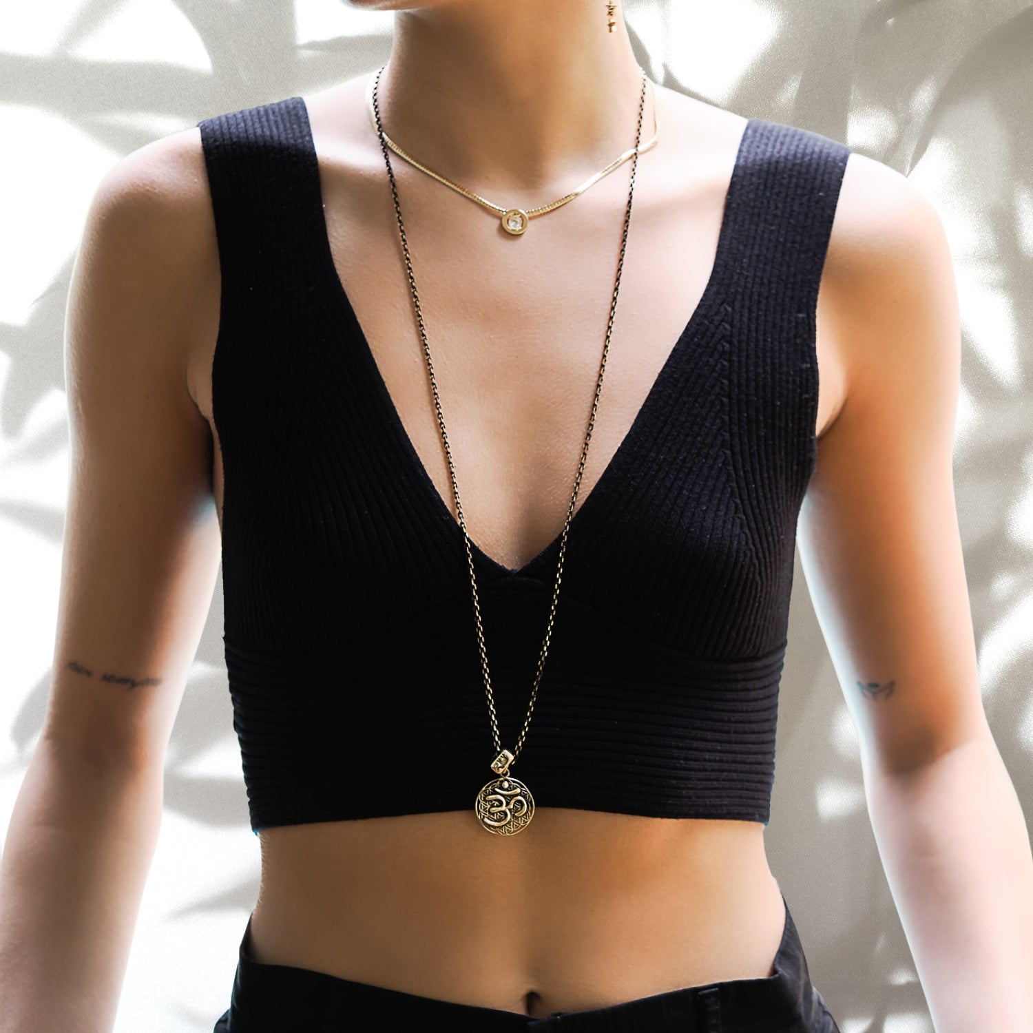 A model wearing the Spiritual Symbols Om Necklace, radiating a sense of spirituality and inner peace.