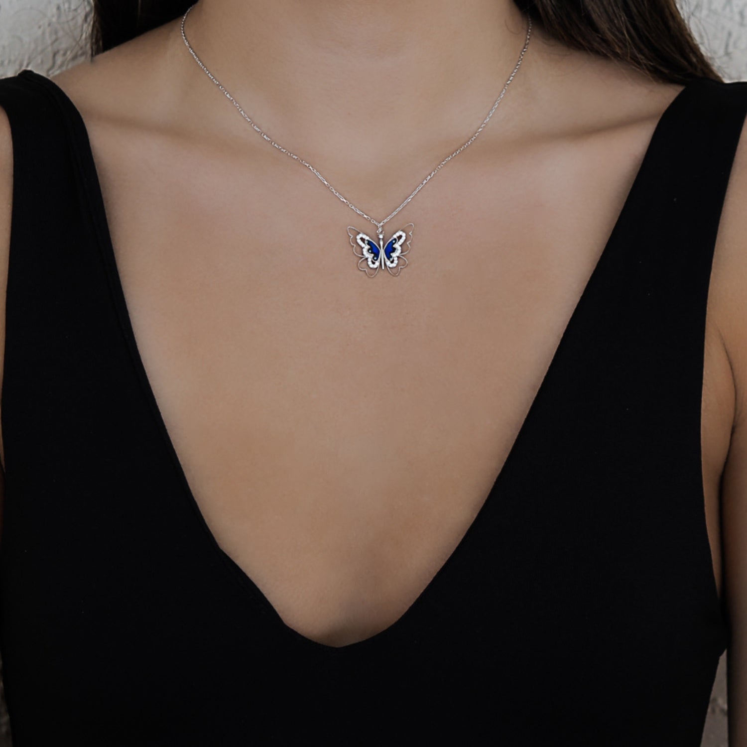 Model wearing the Spiritual Transformation Blue Butterfly Necklace, exuding grace and elegance, and embracing the symbolism of personal transformation.
