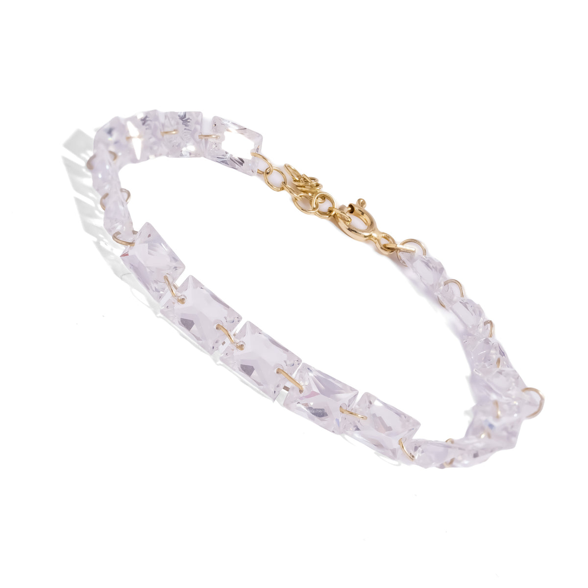 Angled view of the Starlight Emerald Cut Zircon Gold Tennis Bracelet on white