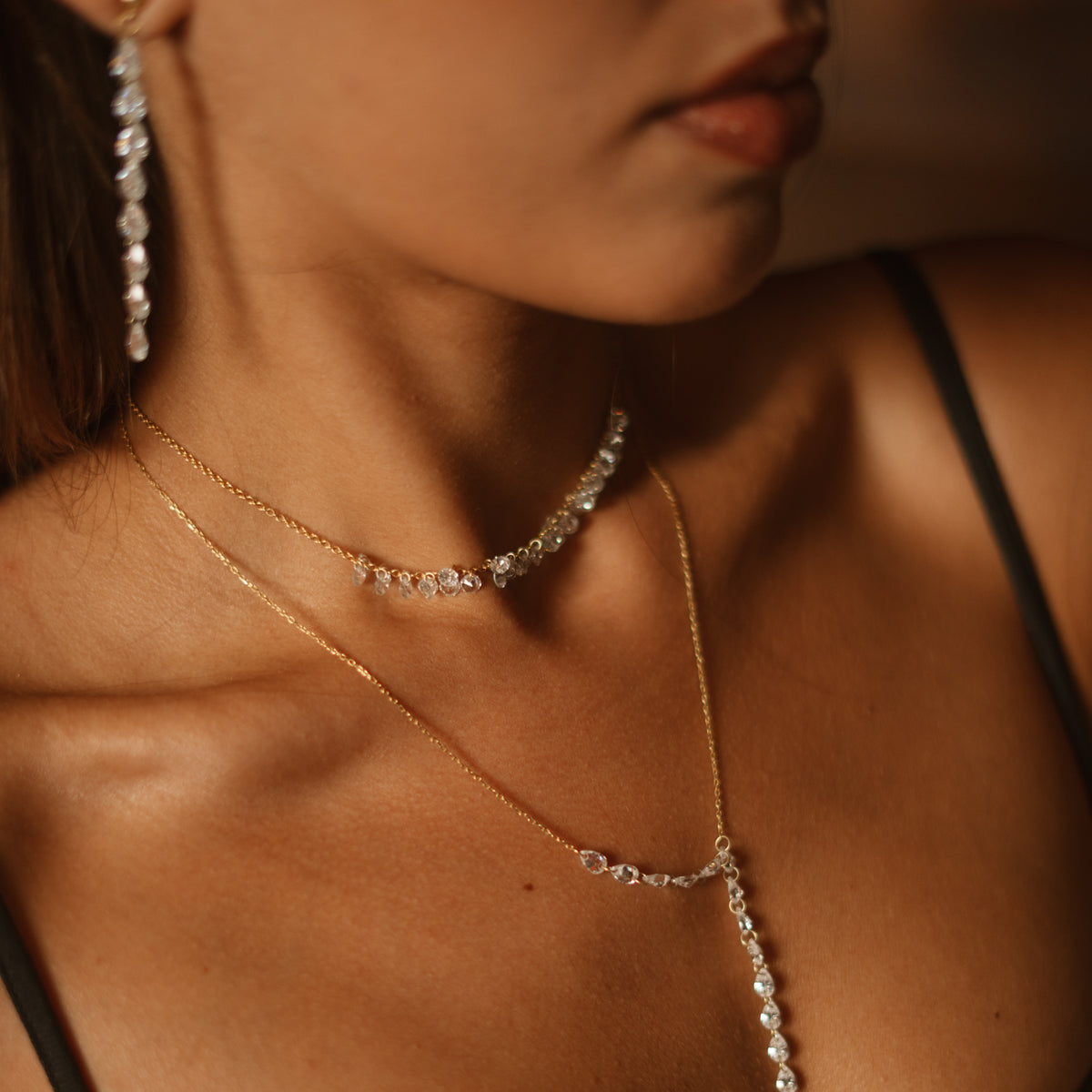 Starlight zircon drop earring on the model beside the Starlight Glow choker