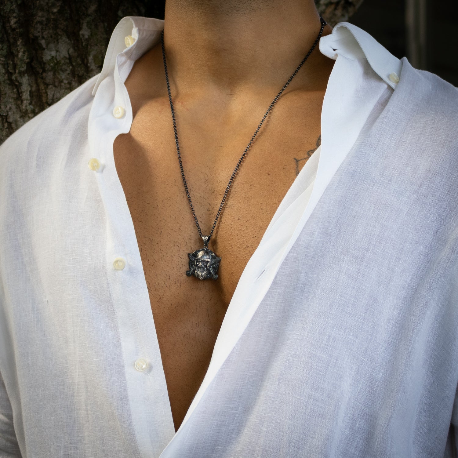 Sterling silver necklace with Viking warrior medallion pendant, rhodium-plated finish, Norse patterns, black accents, strong chain, bold masculine style.