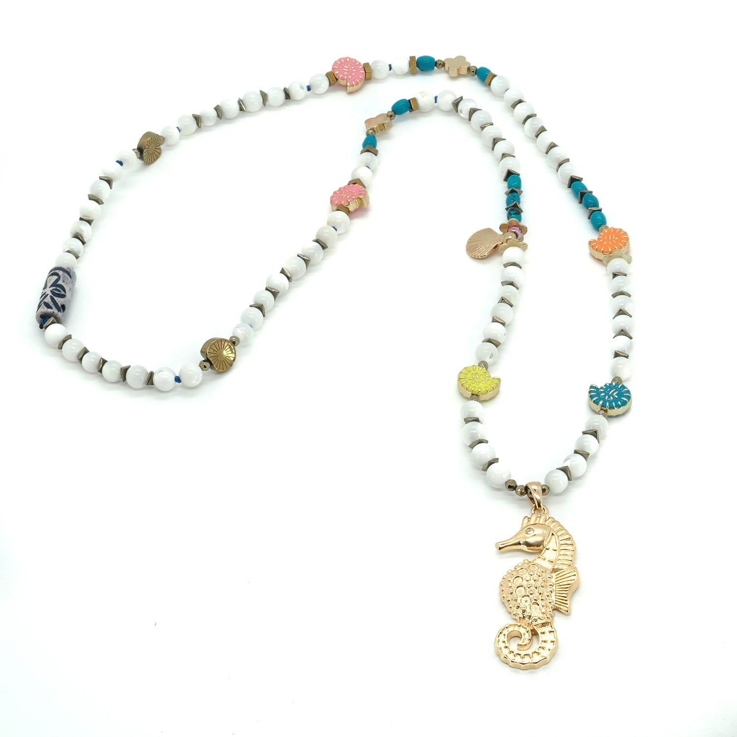 Close-up of 18K gold-plated seahorse pendant with playful summer bead accents

