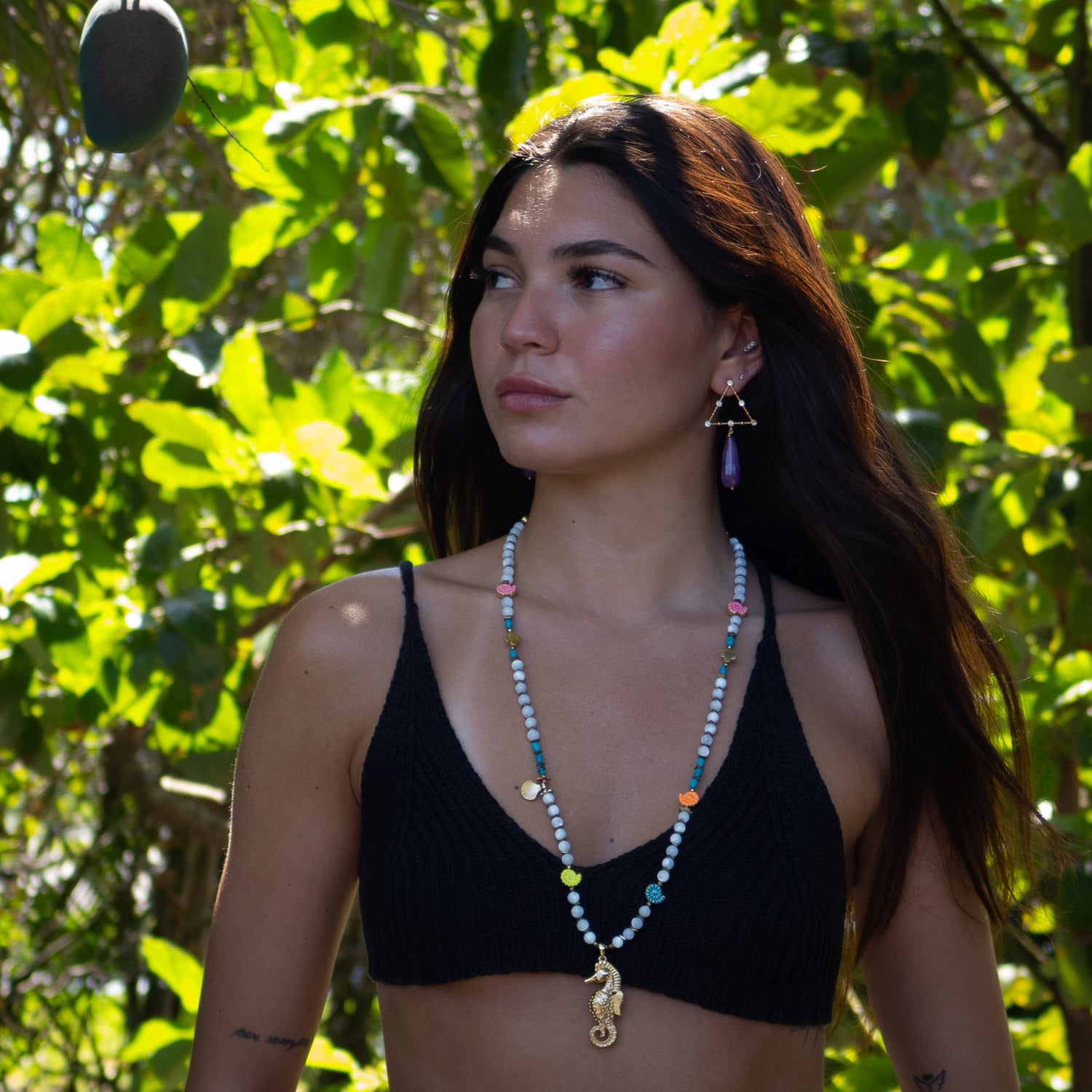 Handmade beach-inspired necklace featuring pearl-style beads and colorful enamel shells

