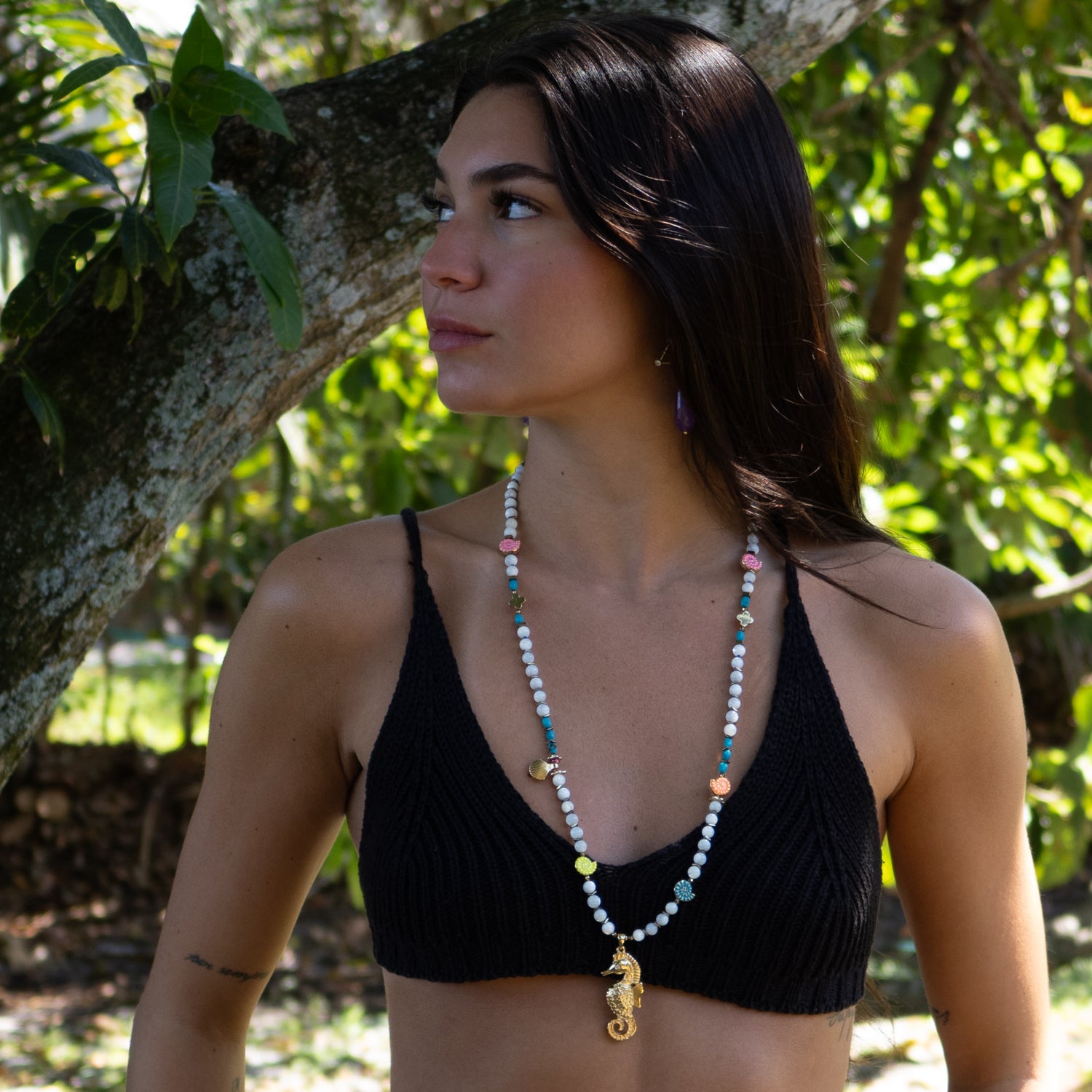 Beachy necklace with gold seahorse charm and layered enamel shell details

