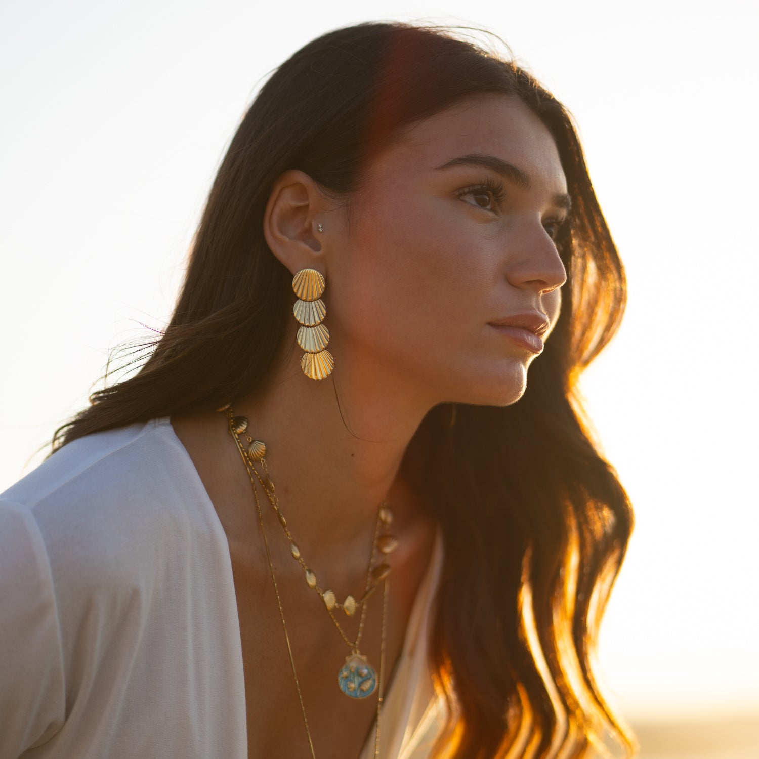 Gold seashell earrings with beachy vibes and protective symbolism