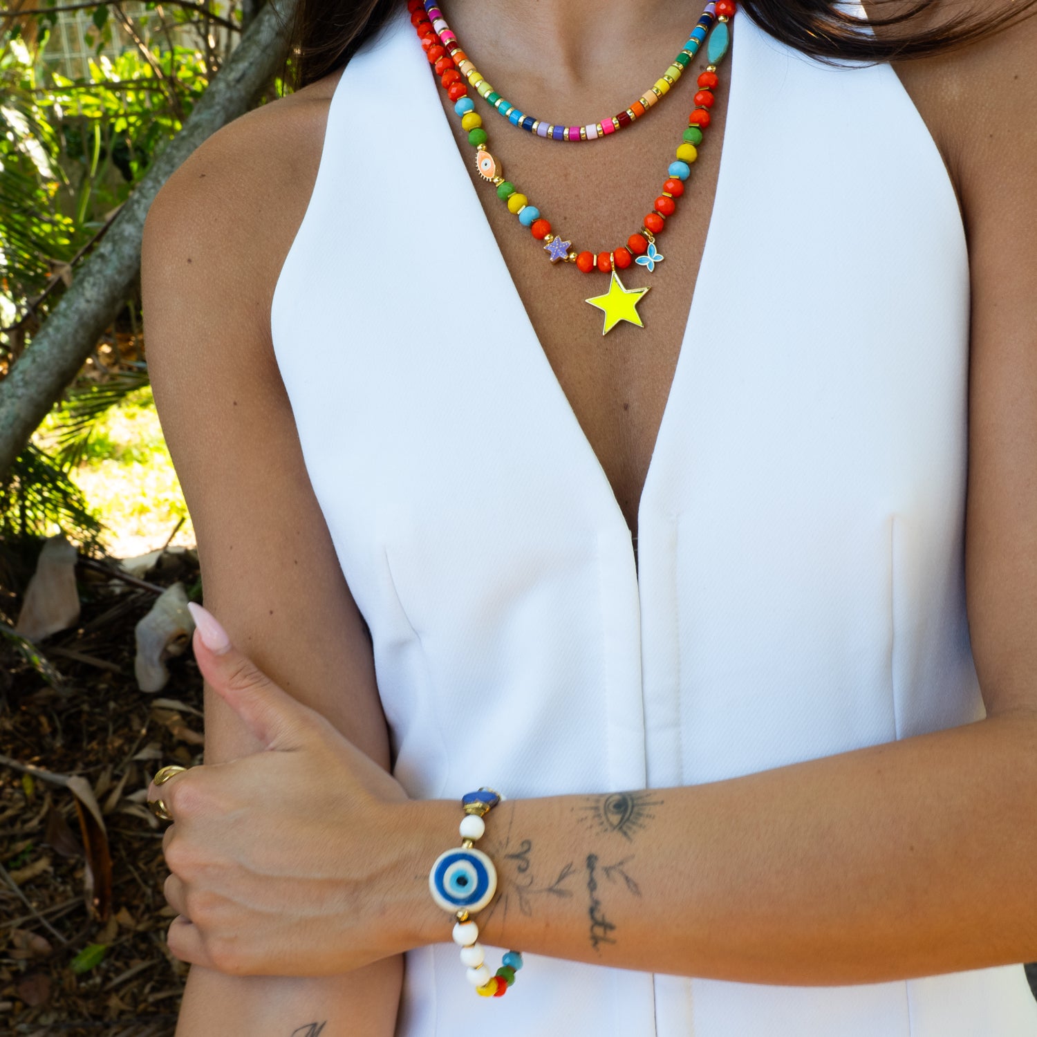 Close-up of neon yellow star pendant on colorful crystal bead necklace, Ebru Jewelry