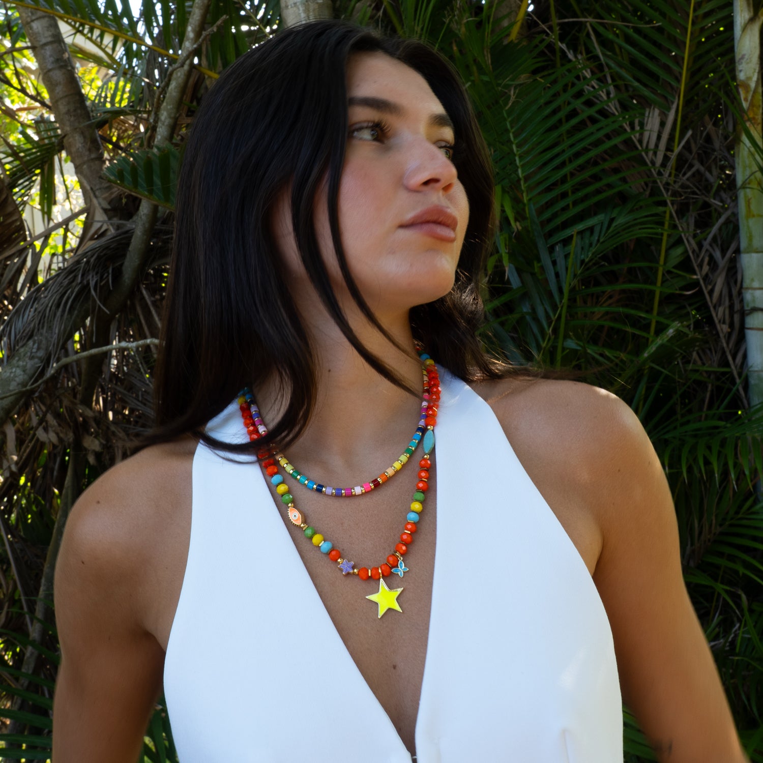 Hand-strung colorful star necklace layered with second beaded necklace by Ebru Jewelry