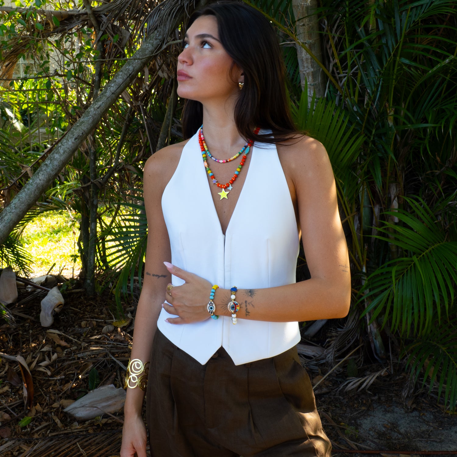 Sunshine Star beaded necklace with butterfly charm on model, joyful summer look