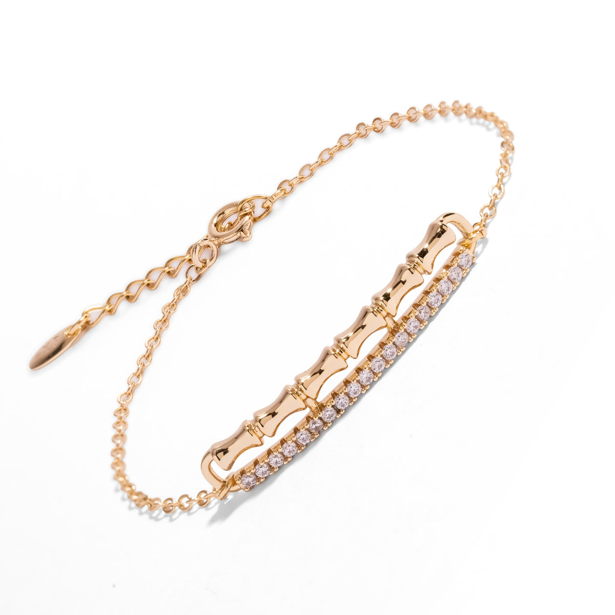 Golden Bamboo Pave Zircon Minimalist Chain Bracelet laid diagonally on white, gold bamboo bar and pave zircon row