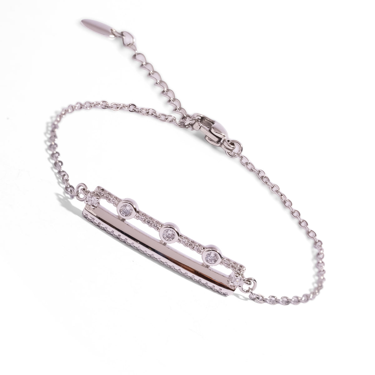 Three Lights sterling silver chain bracelet at an angle, showing the lobster clasp and extender with a leaf tag
