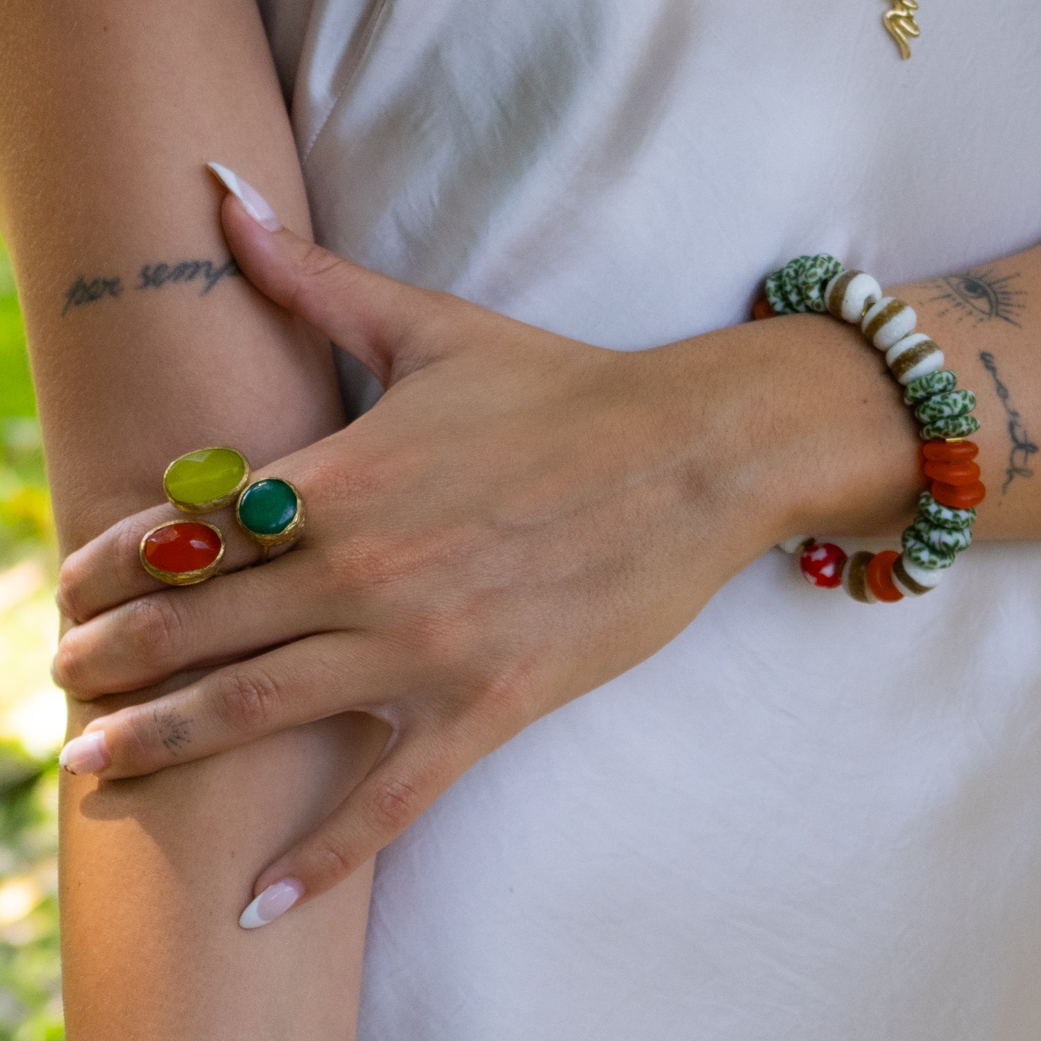 Handmade bracelet featuring red and white central energy bead and ceramic nuggets.

