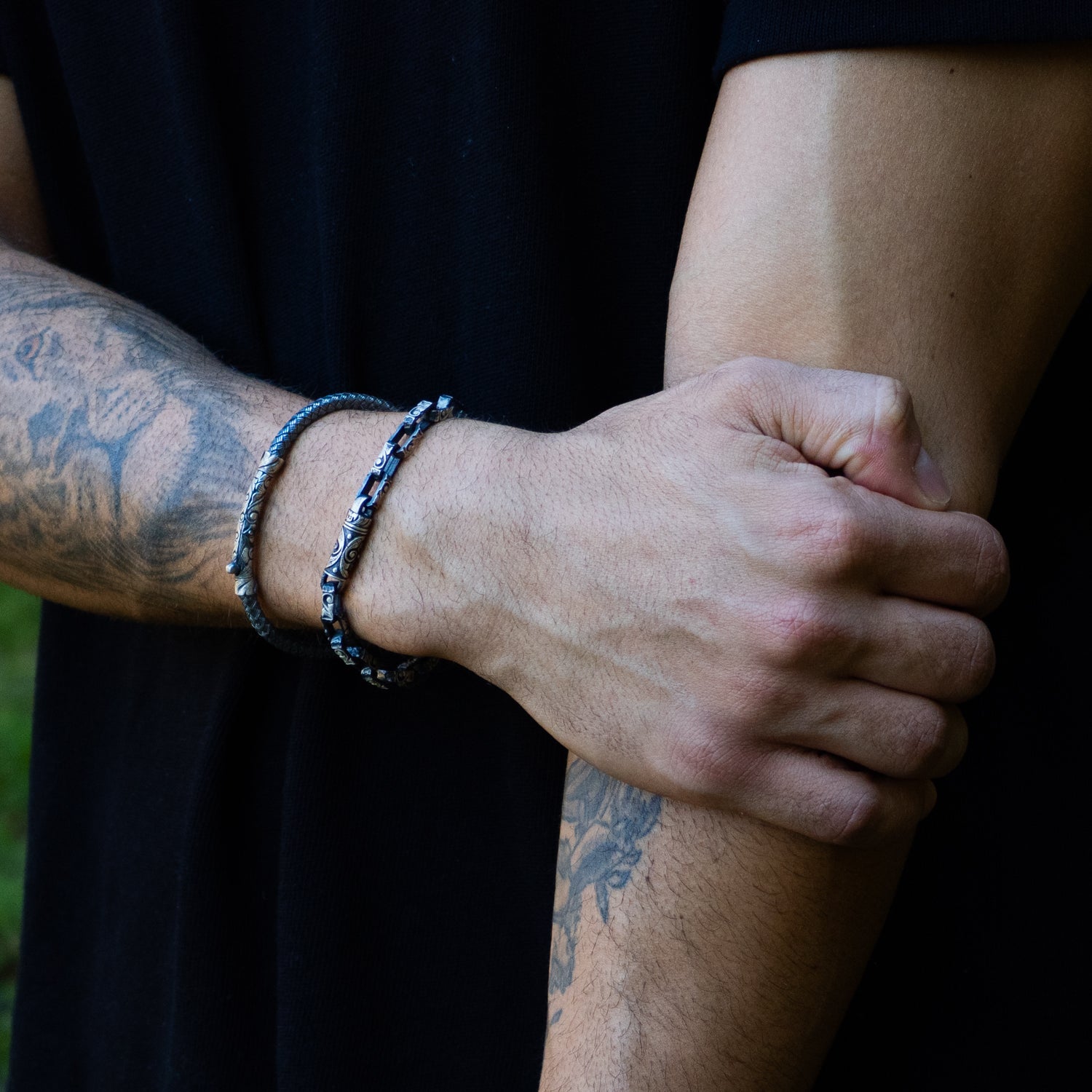 Tribal Strength bangle in polished sterling silver with intricate tribal engravings, masculine style, handcrafted, adjustable fit.