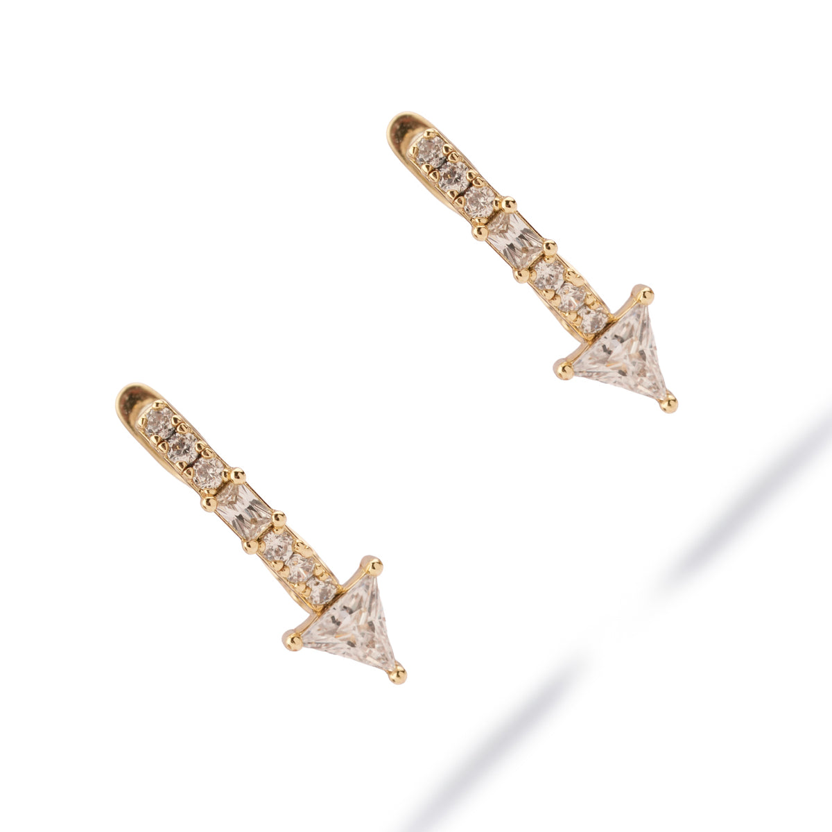 Pair of Trillion Arrow Pave Zircon Gold Stud Earrings at an angle, showing the baguette between the round zircons