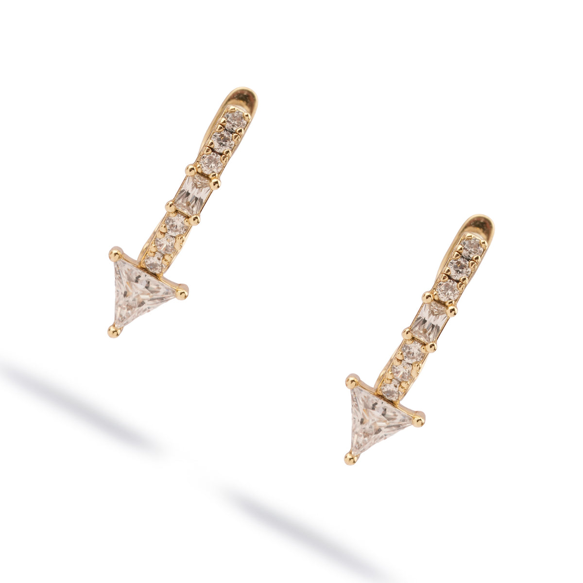 Trillion Arrow Pave Zircon Gold Stud Earrings laid diagonally on white, arrow points facing down