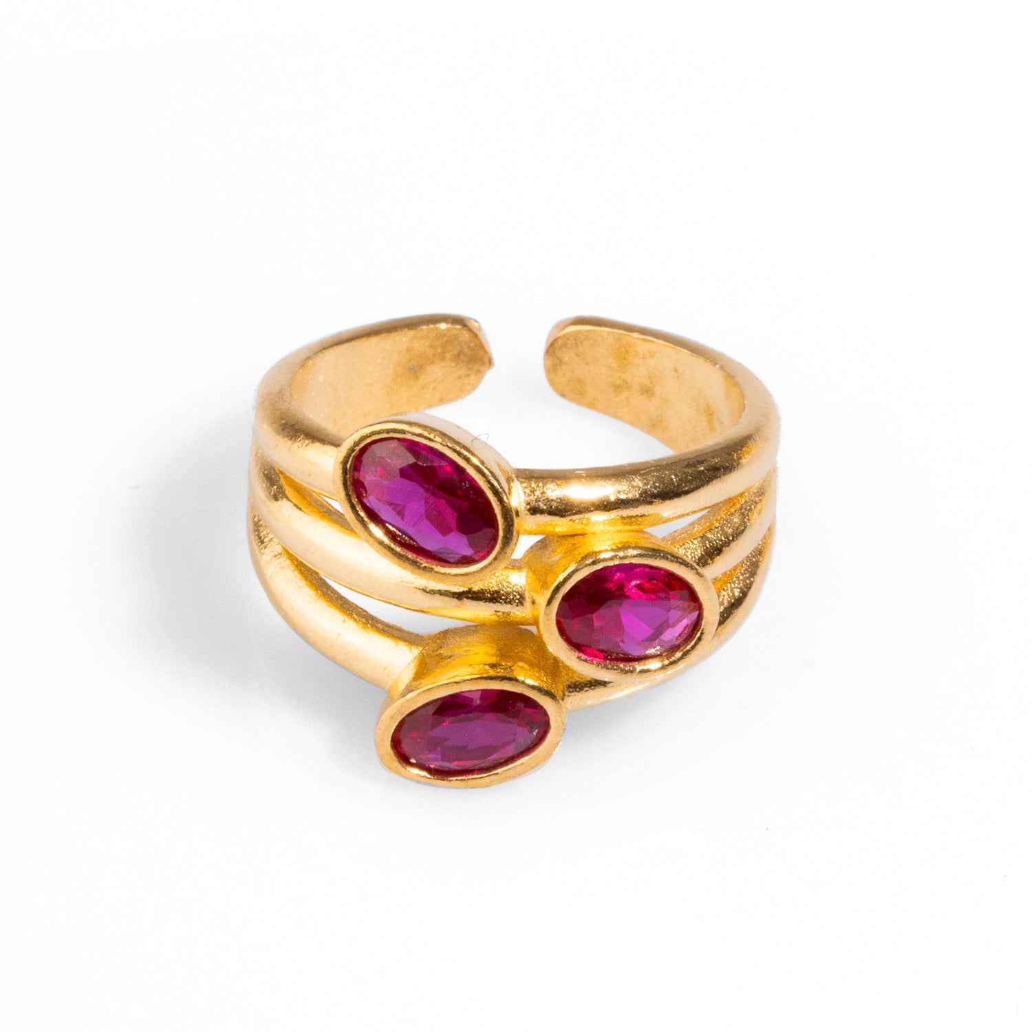 Luxurious cocktail ring featuring three oval ruby gemstones set in 24k gold-plated brass, with an adjustable band for a perfect fit.
