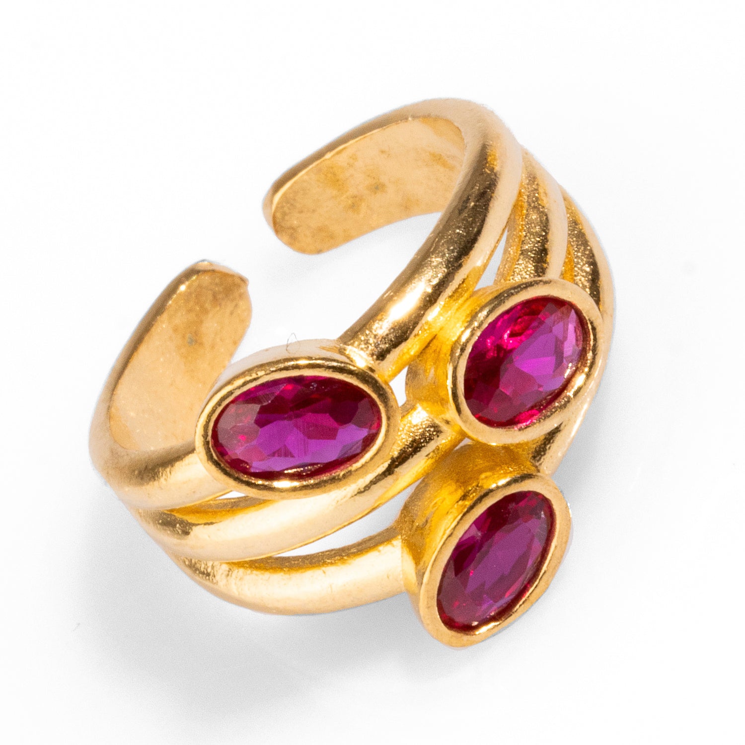 Statement ring featuring three ruby gemstones set in a 24k gold-plated brass base, adjustable for comfort and style.
