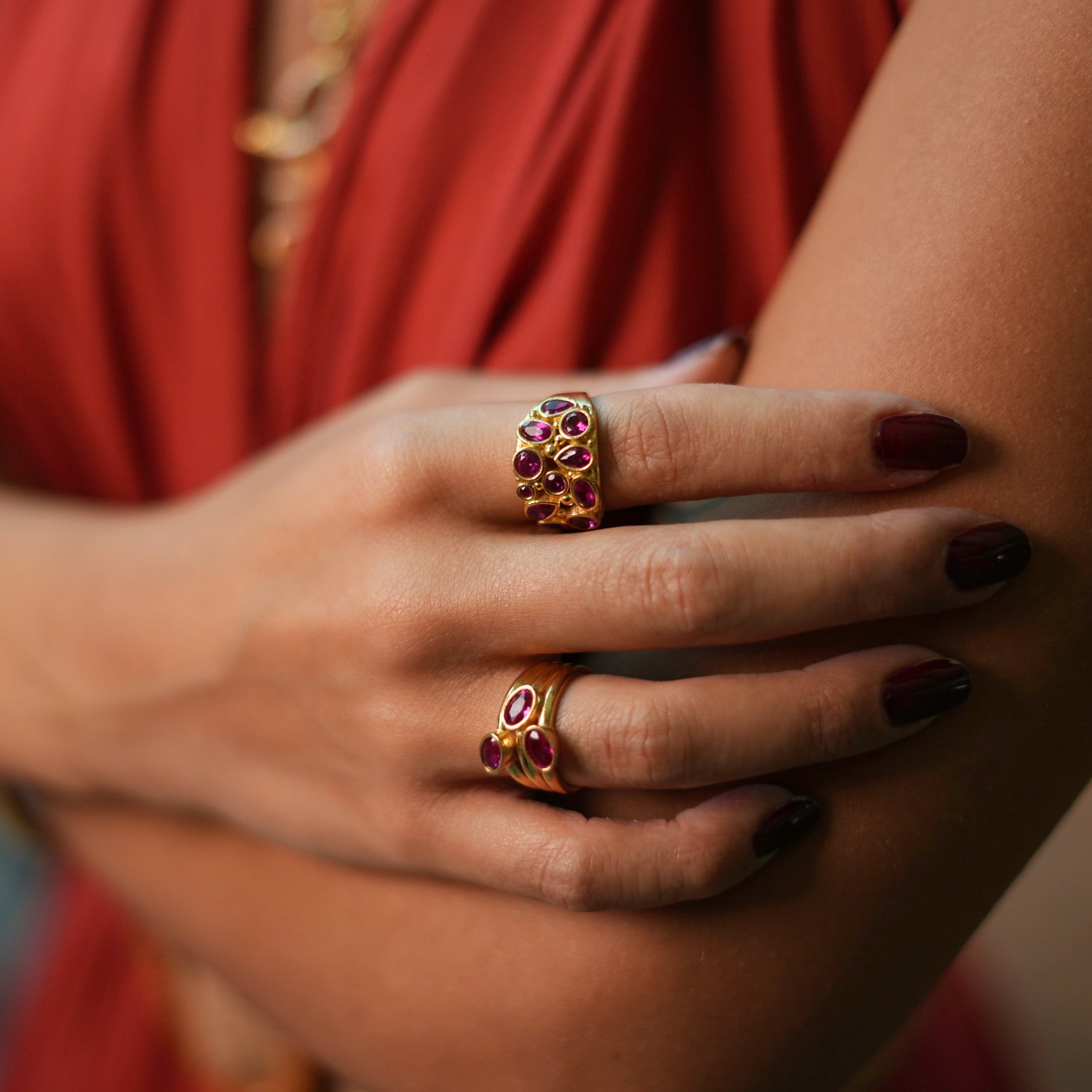 Elegant cocktail ring with trio of oval rubies on a 24k gold-plated base, adjustable size for versatile styling.
