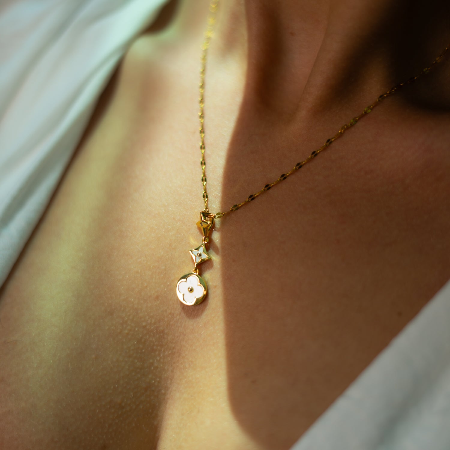 Layer-friendly charm necklace with star and floral pendants