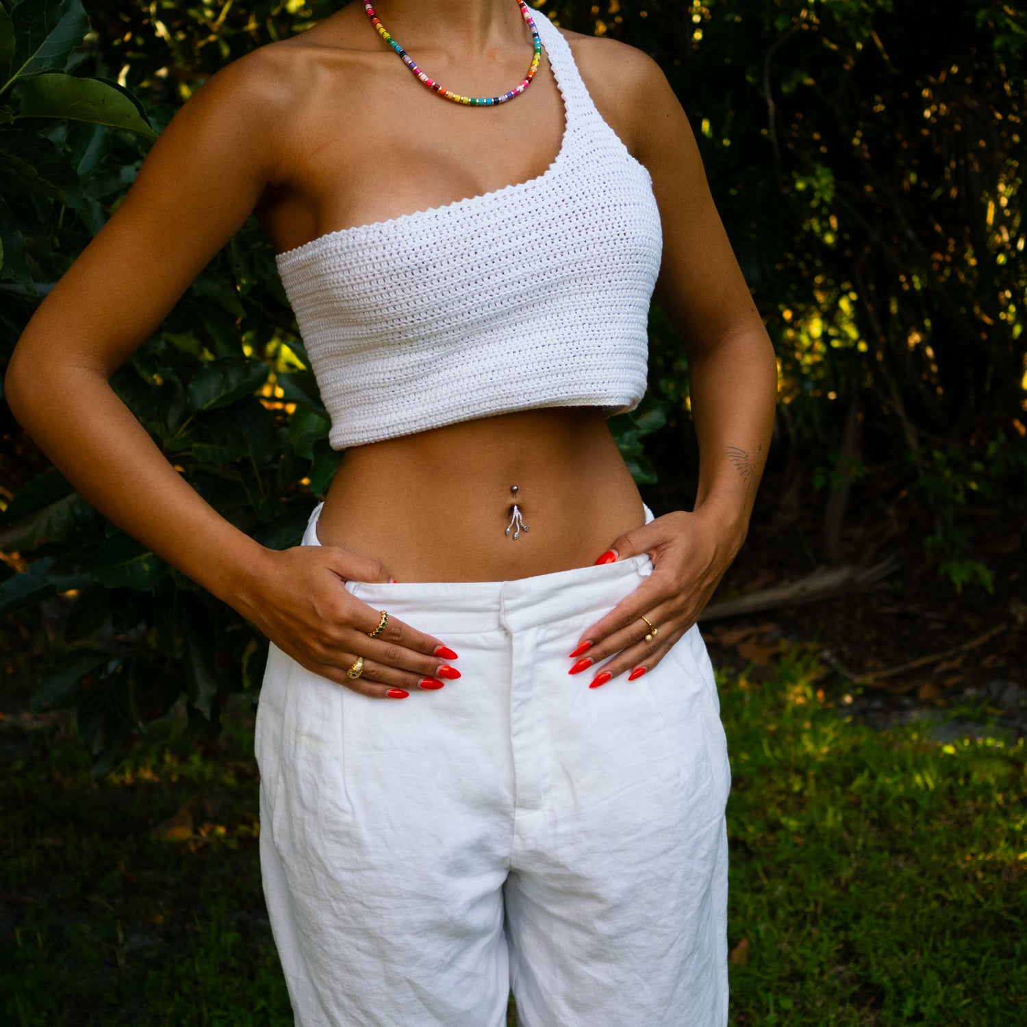 Sterling silver belly piercing with three cascading teardrop cubic zirconia stones and modern branch design, elegant sparkly style.