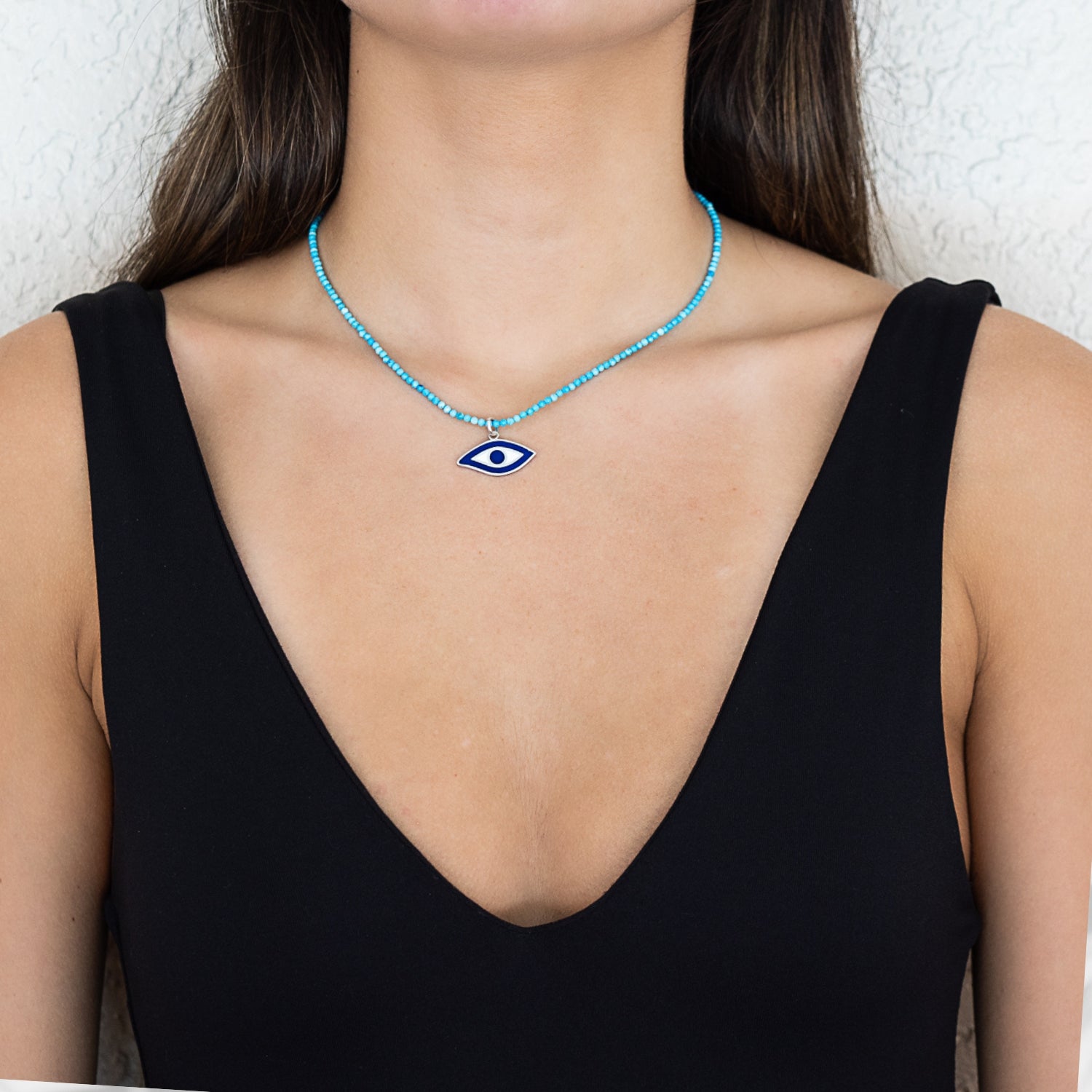 The Turquoise Evil Eye Protection Necklace beautifully worn by the model, showcasing its unique design and vibrant colors.