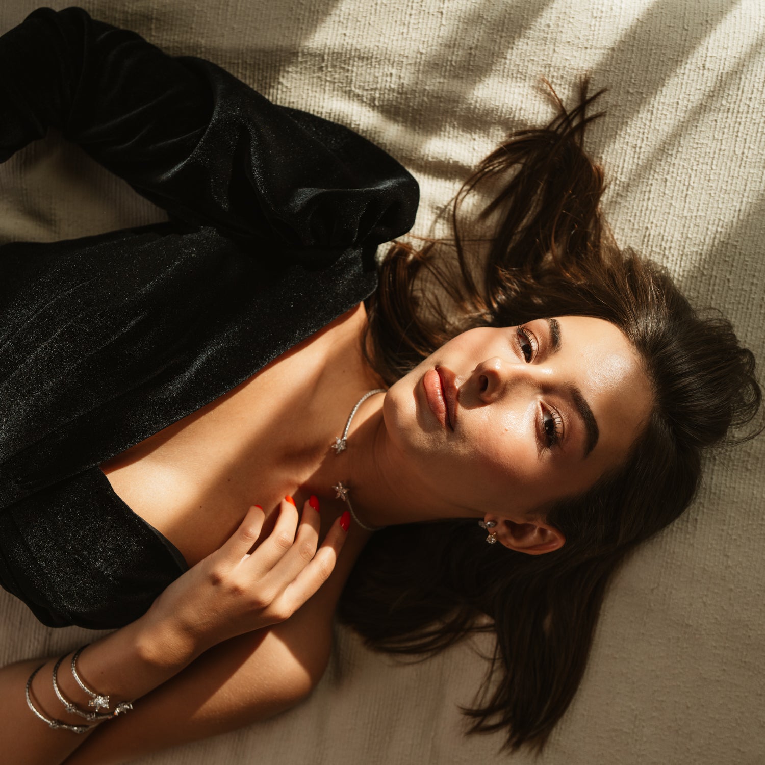 Sterling silver collar necklace and stacked silver bangles worn in soft afternoon light