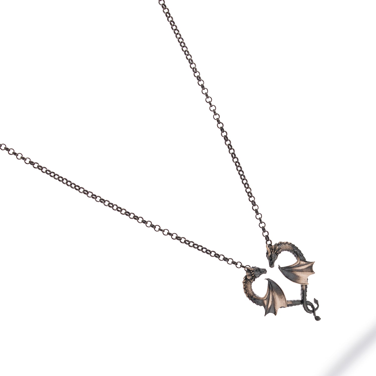 Sterling silver necklace with twin dragons forming a heart pendant, rhodium finish, intricate dragon scales, black accents, bold masculine style.