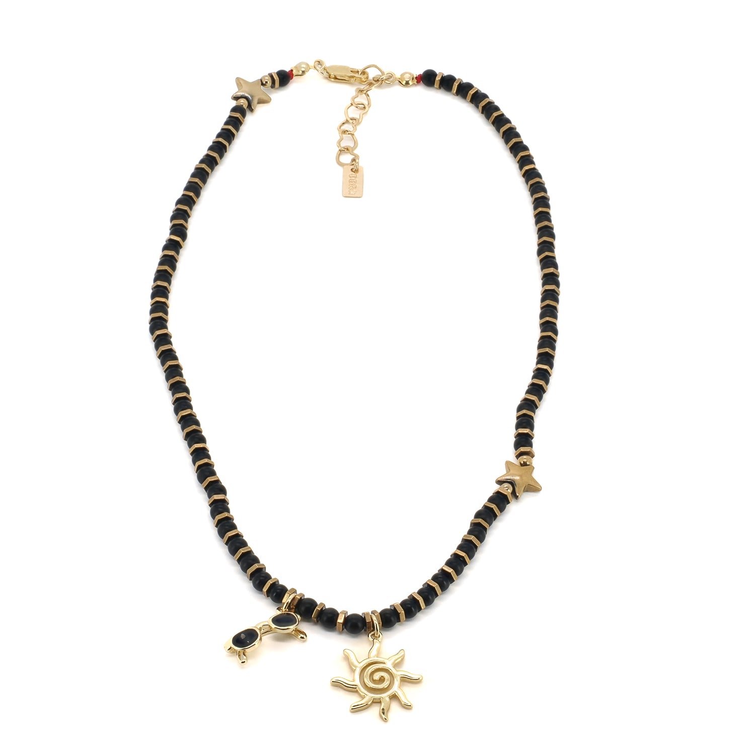 Detail view of matte black onyx beads with gold-plated hematite star and spacer accents