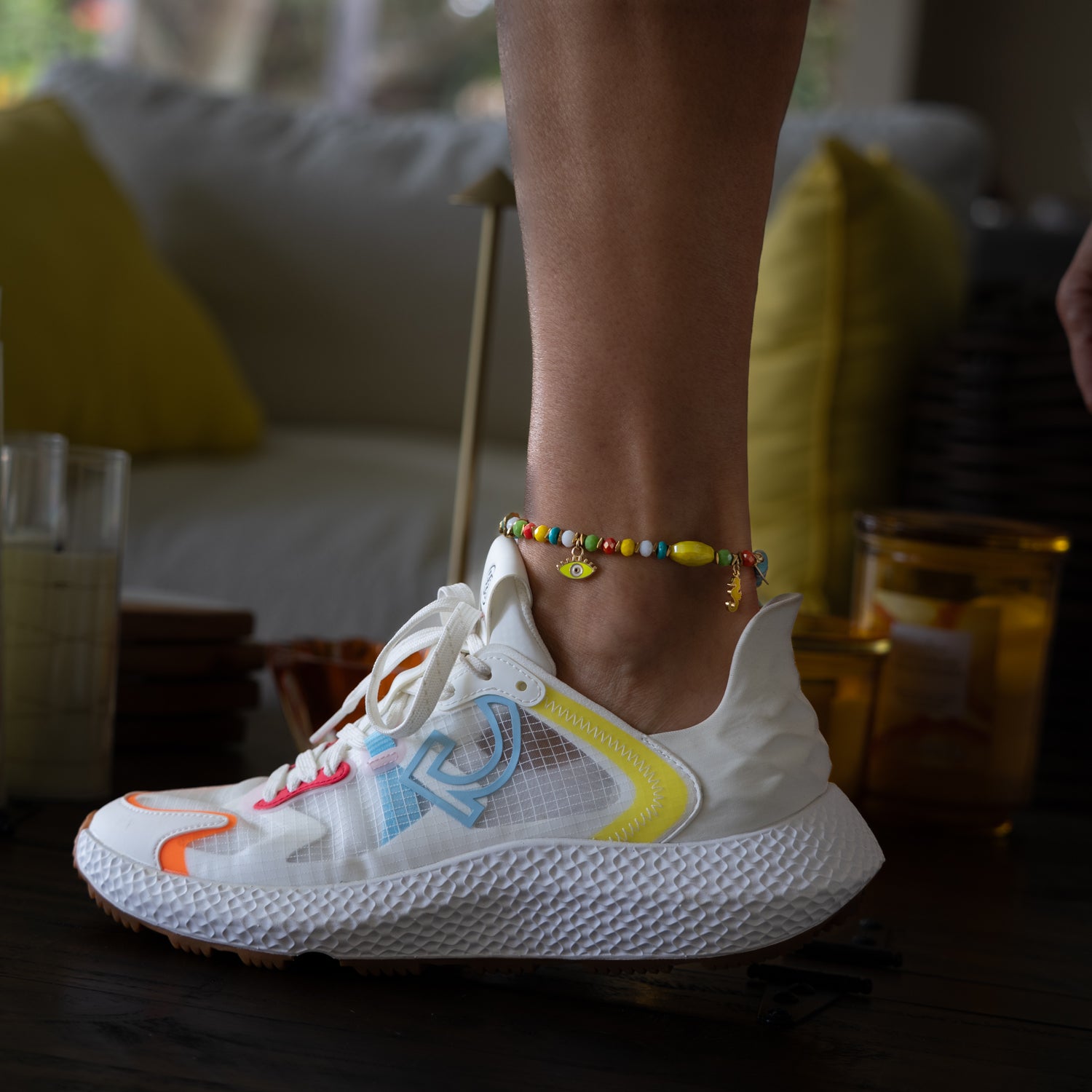 Lucky Charms Colorful Anklet showing all beads and charms on ankle with white shoe — summer vacation aesthetic
