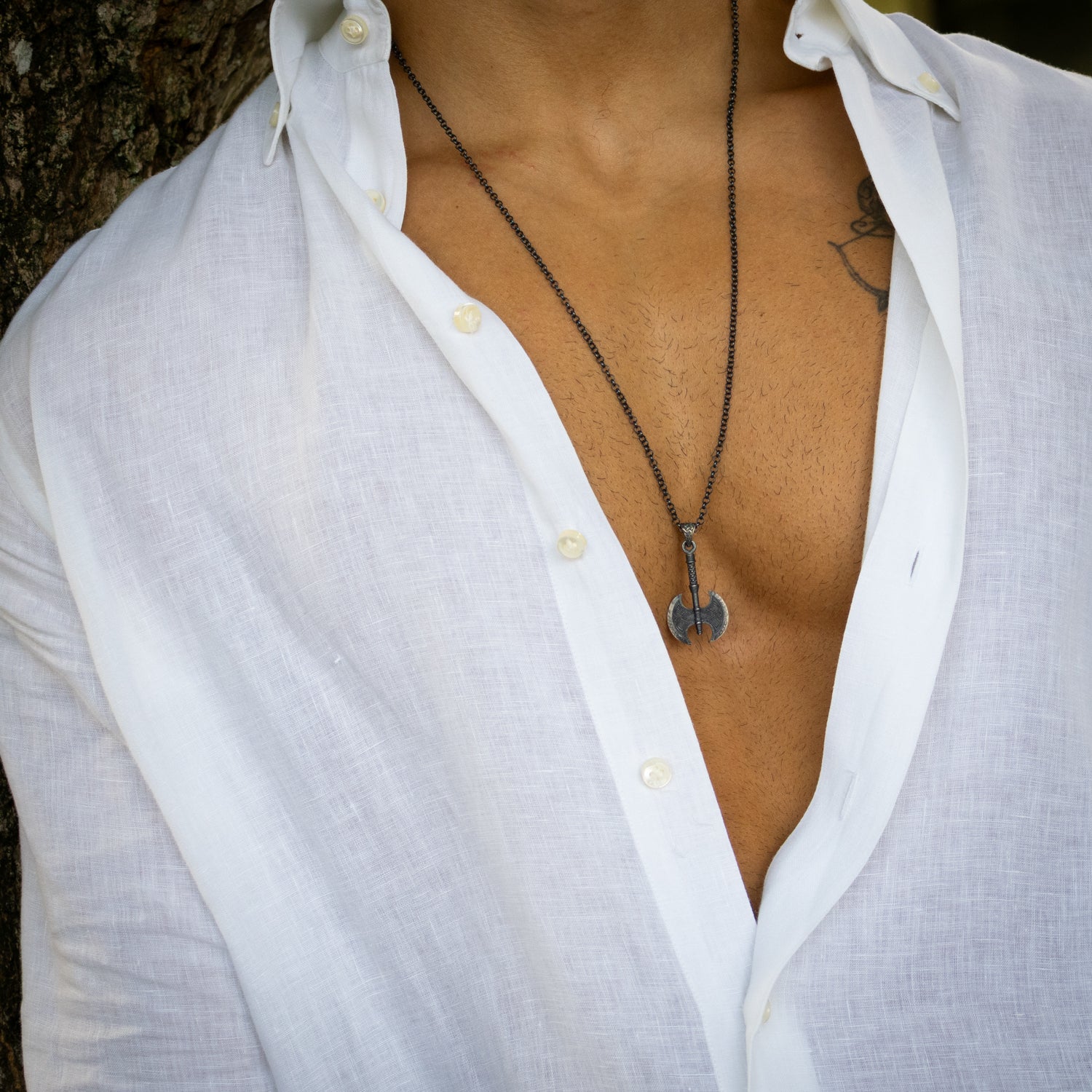 Sterling silver necklace with Viking axe pendant, rhodium finish, intricate engraved details, bold Norse warrior style symbolizing strength.