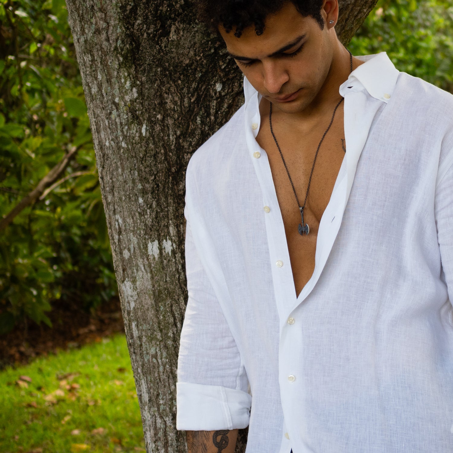 Sterling silver necklace with Viking axe pendant, rhodium finish, intricate engraved details, bold Norse warrior style symbolizing strength.