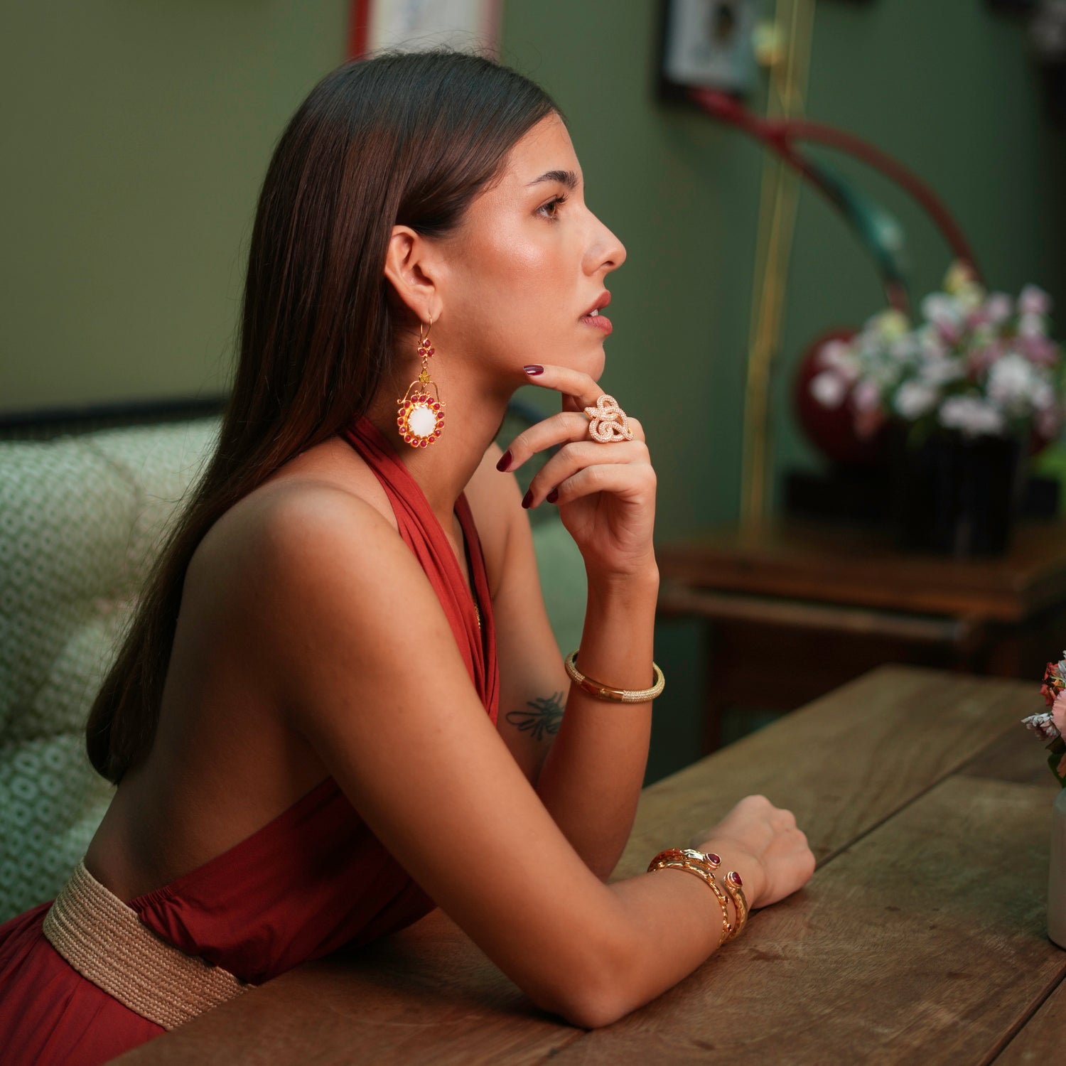 Bold vintage-style dangle earrings with a floral arrangement, including a mother of pearl stone and vibrant ruby and jade accents.
