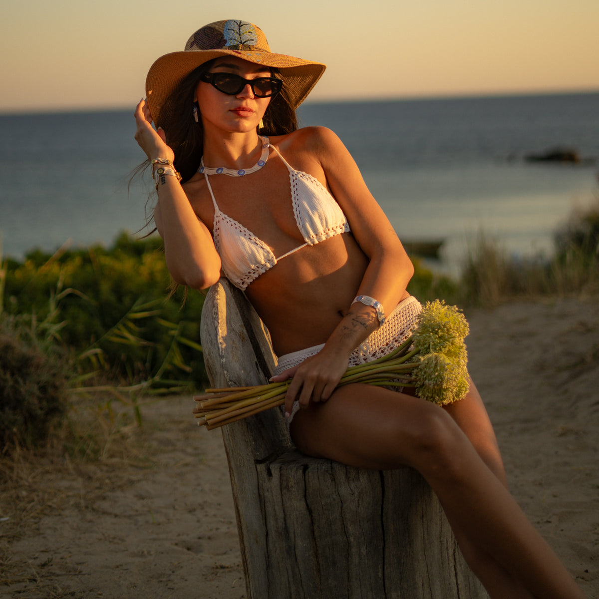 The Cobalt Bloom enamel bracelet and choker worn together at the shore at sunset