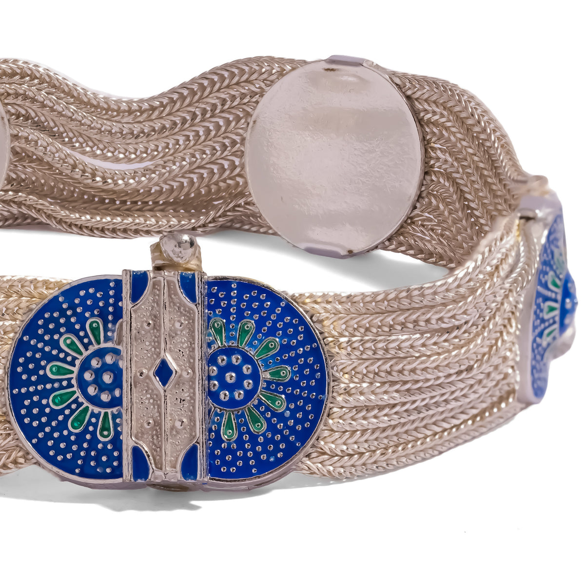 Close detail of the cobalt enamel bloom medallion split down the center by the concealed clasp